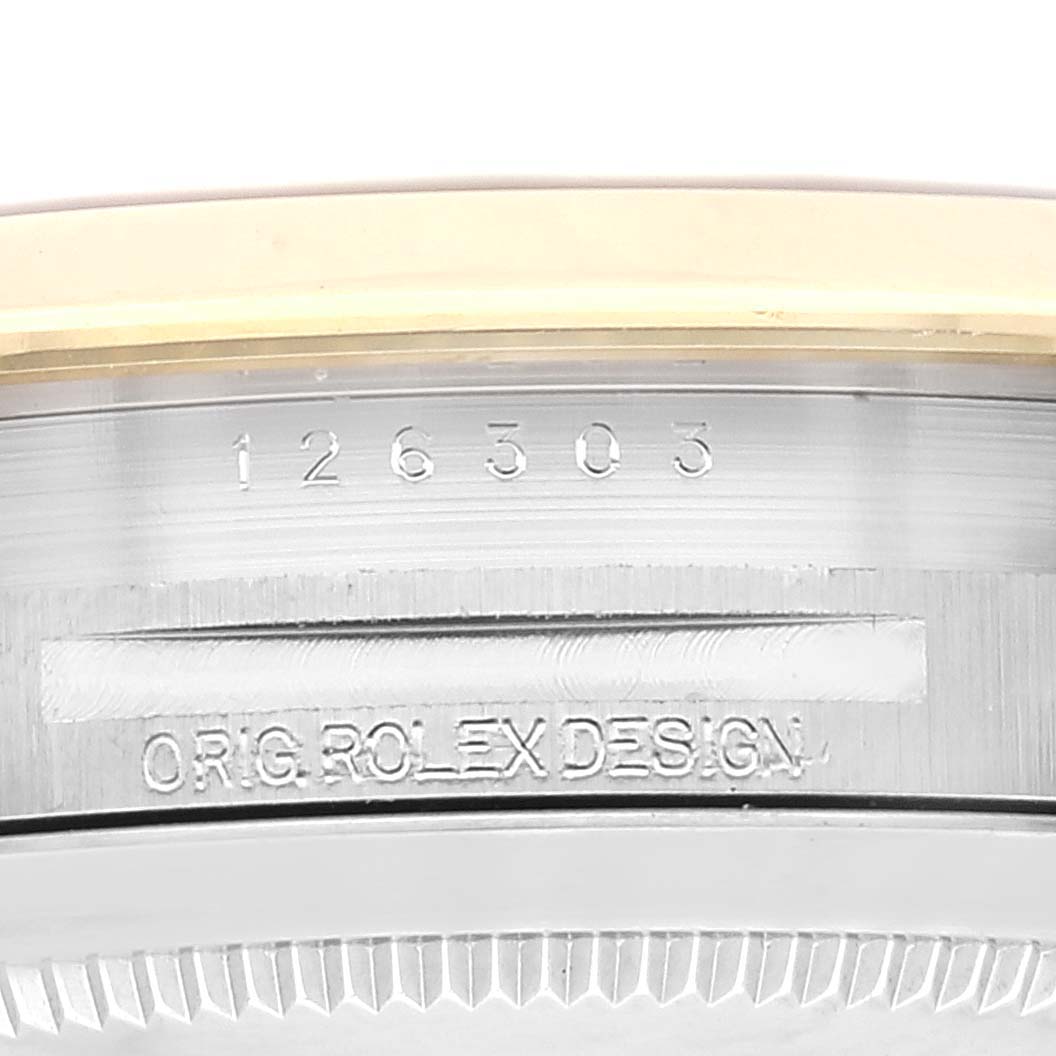 This image shows a close-up view of the case side of a Rolex Datejust 41 126303 Men
s Steel and Gold (two tone) Black Dial 126303 Men
s Steel and Gold (two tone) Black Dial model, displaying the engraved model number and "ORIG. ROLEX DESIGN."