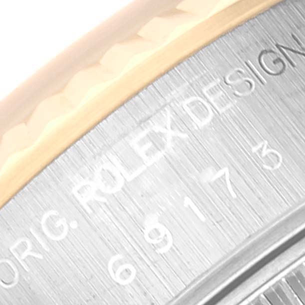 This close-up angle shows part of the bezel and engraved text on the side of the Rolex Datejust 69173 Women's Steel and Gold (two tone) Blue Dial 69173 Women's Steel and Gold (two tone) Blue Dial watch.