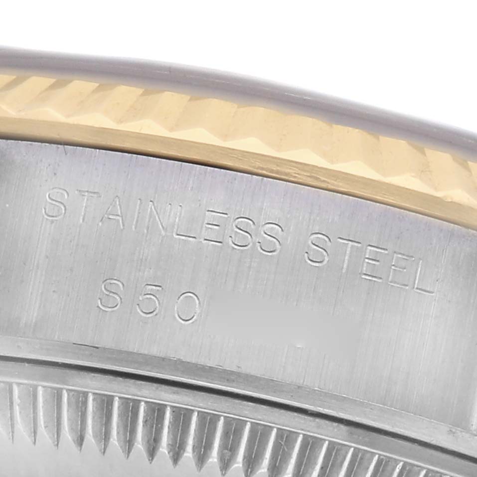The image shows a close-up of the side of a Rolex Datejust 69173 Women
s Steel and Gold (two tone) Blue Dial 69173 Women
s Steel and Gold (two tone) Blue Dial watch, highlighting the stainless steel part and edge details.