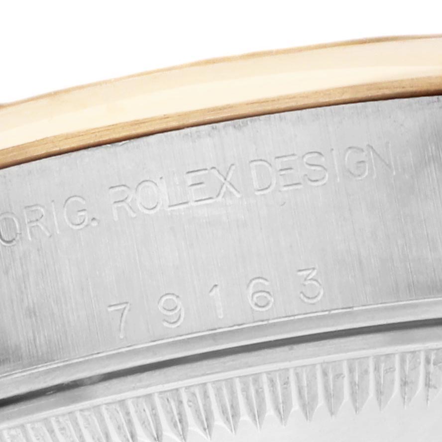 The image shows a close-up of the side of a Rolex Datejust 79163 Women's Steel and Gold (two tone) Grey Dial 79163 Women's Steel and Gold (two tone) Grey Dial, featuring engraved model details.