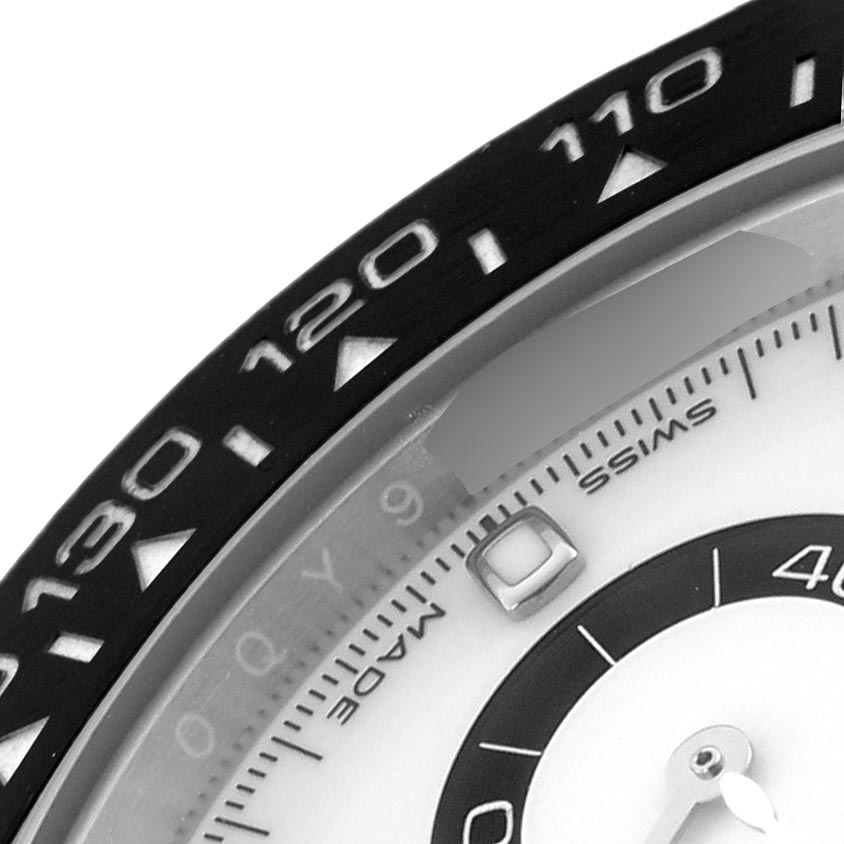 The image shows a close-up of the bezel and part of the dial of a Rolex Daytona 116500LN Men's Stainless Steel White Dial 116500LN Men's Stainless Steel White Dial, focusing on the tachymetric scale.