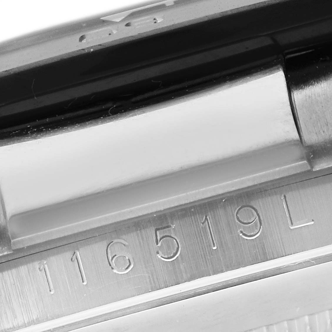 Close-up of the Rolex Daytona 116519 Men's White Gold Grey Dial 116519 Men's White Gold Grey Dial model's serial number and part of the bracelet attachment.