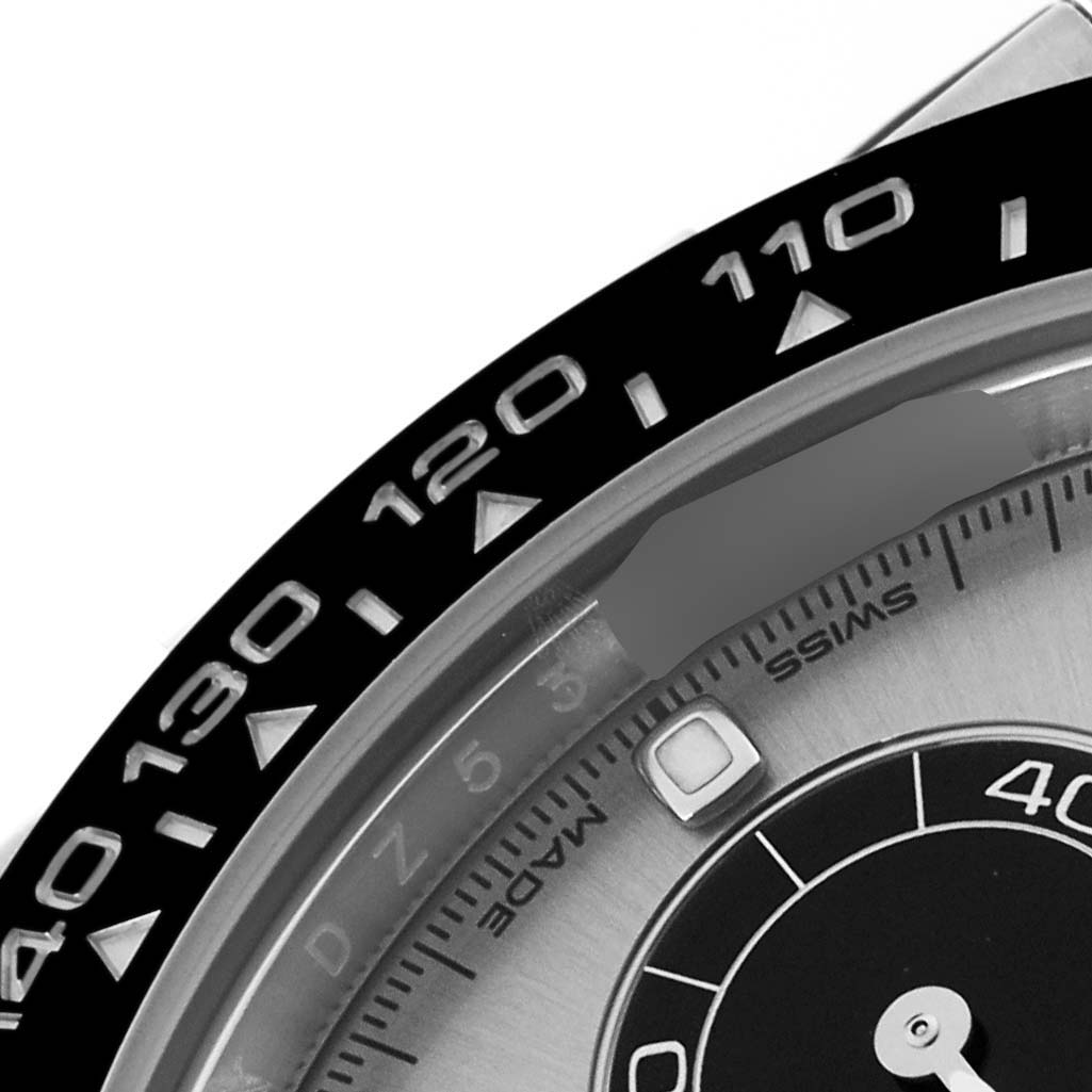 This image shows a close-up of the bezel and part of the dial of a Rolex Daytona 116519 Men's White Gold Grey Dial 116519 Men's White Gold Grey Dial watch.