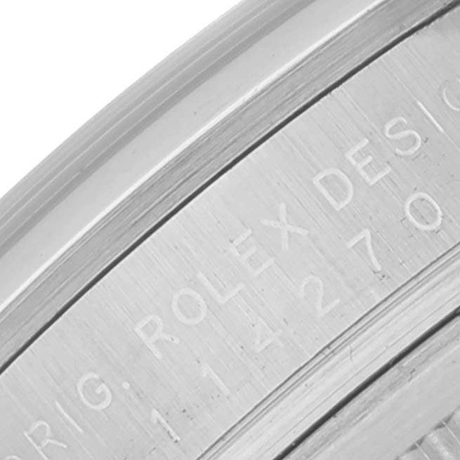 The image shows a close-up of the engraved inner bezel of a Rolex Explorer 114270 Men
s Stainless Steel Black Dial 114270 Men
s Stainless Steel Black Dial watch.