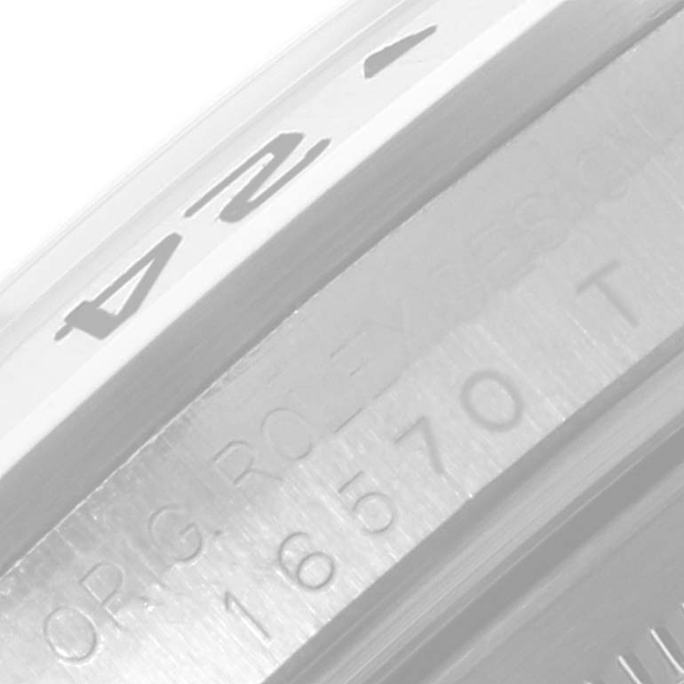 The image shows a close-up of the bezel and part of the engraved case back of a Rolex Explorer 16570 Men's Stainless Steel Black Dial 16570 Men's Stainless Steel Black Dial model watch.