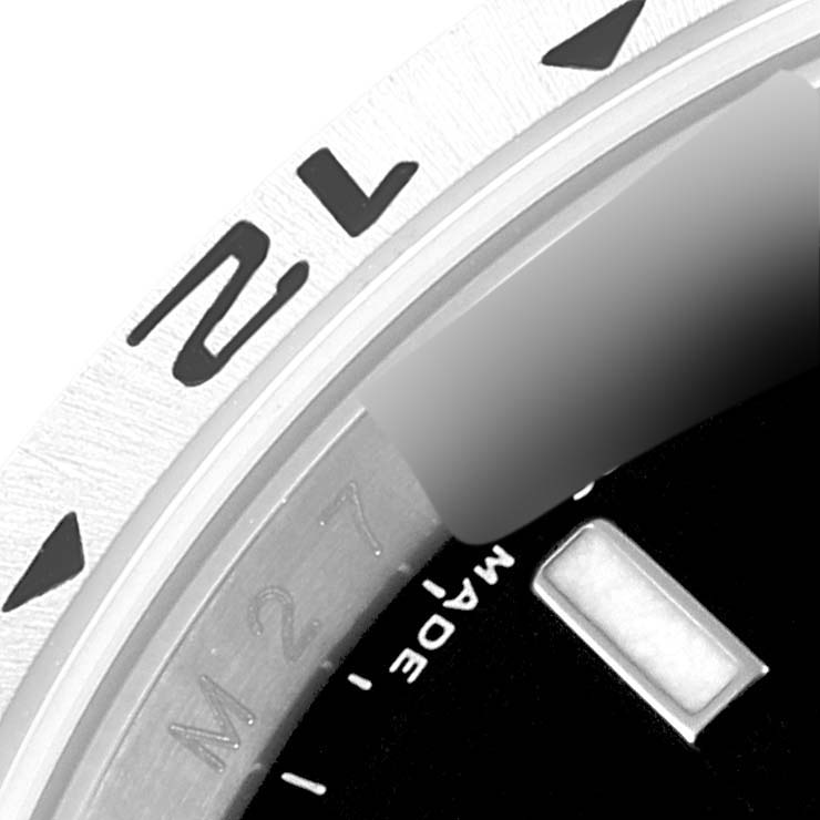 The image shows a close-up of the bezel and dial of a Rolex Explorer 16570 Men's Stainless Steel Black Dial 16570 Men's Stainless Steel Black Dial watch, highlighting the "12" marker and part of the minute track.