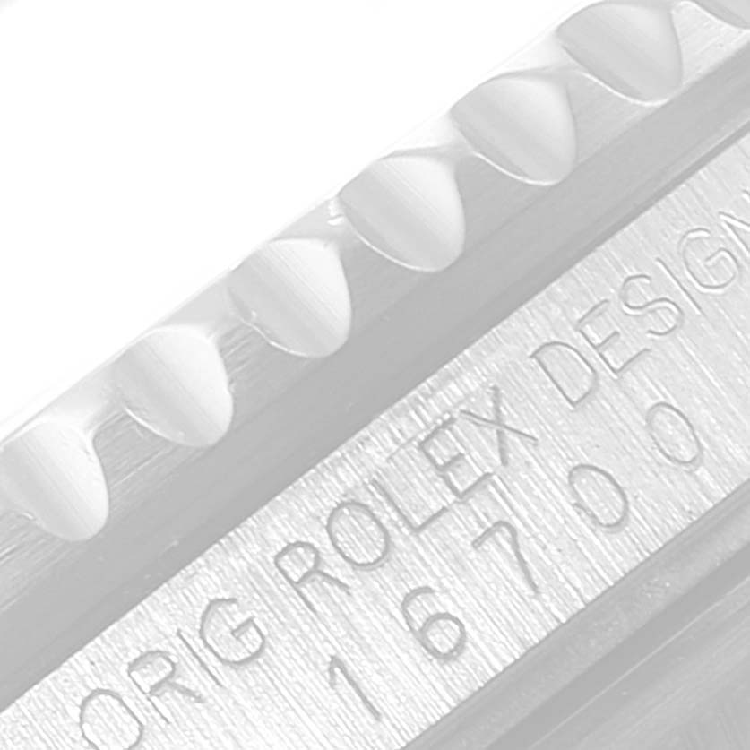 The image shows a close-up of the side view of the bezel and case, with "Rolex Design 16700" engraved on the GMT-Master model by Rolex.