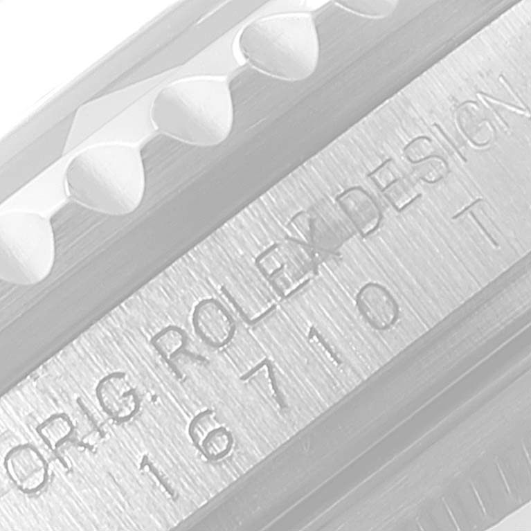 This close-up image shows the side of the bezel and case band of a Rolex GMT-Master 16710 Men
s Stainless Steel Black Dial 16710 Men
s Stainless Steel Black Dial watch, displaying text and model number details.