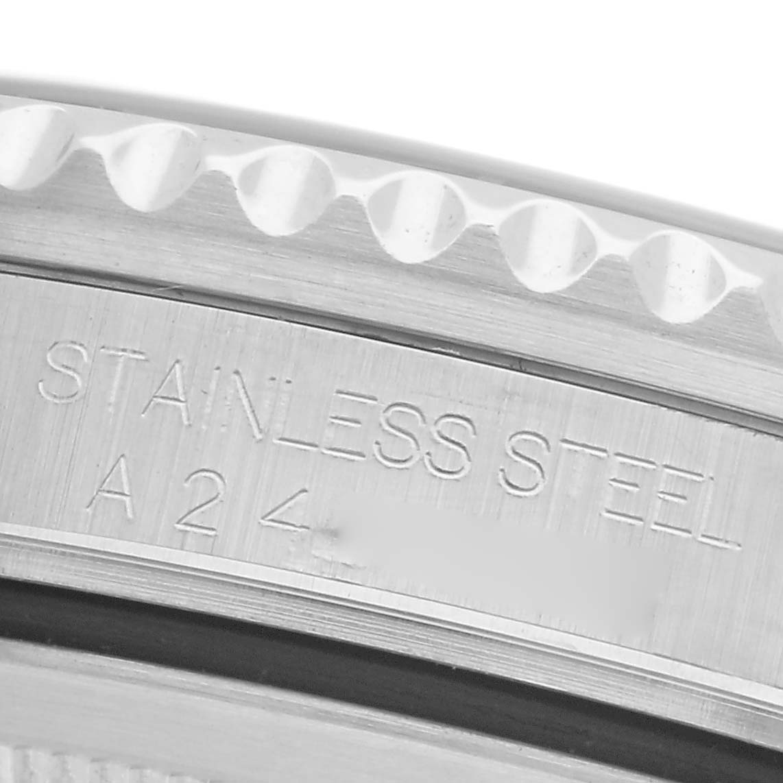 The image shows a close-up of the Rolex GMT-Master 16700 Men
s Stainless Steel Black Dial 16700 Men
s Stainless Steel Black Dial
s bezel with engraved "STAINLESS STEEL" and a reference number.