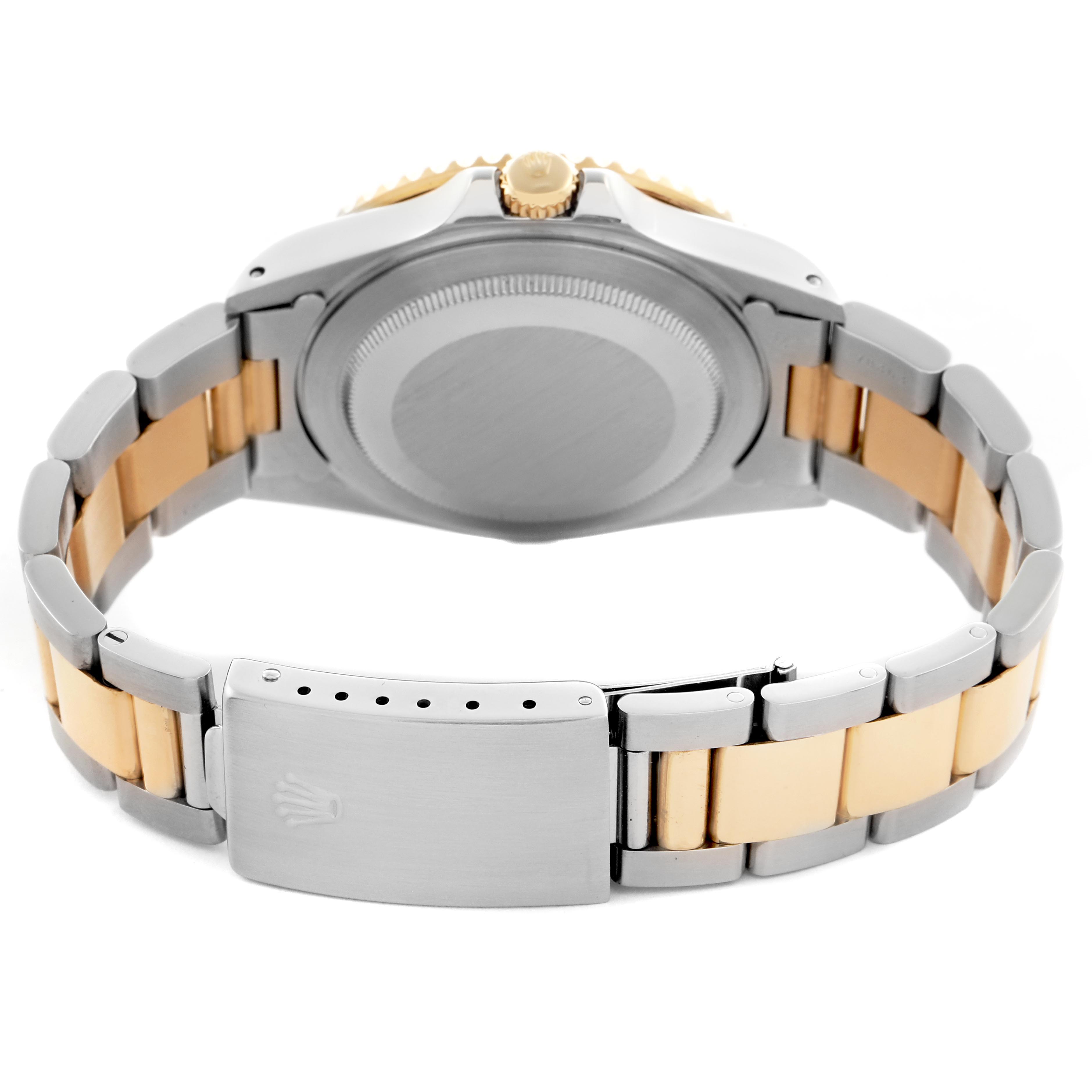 The image shows the back of a Rolex GMT-Master 16713 Men
s Steel and Gold (two tone) Champagne Dial 16713 Men
s Steel and Gold (two tone) Champagne Dial watch, highlighting the bracelet and clasp.