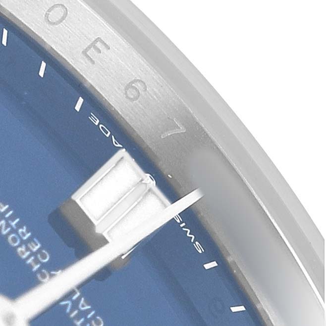 The image shows a close-up of the Rolex Oyster Perpetual 124300 Men's Stainless Steel Blue Dial watch dial, focusing on the indices, part of the hand, and the bezel.