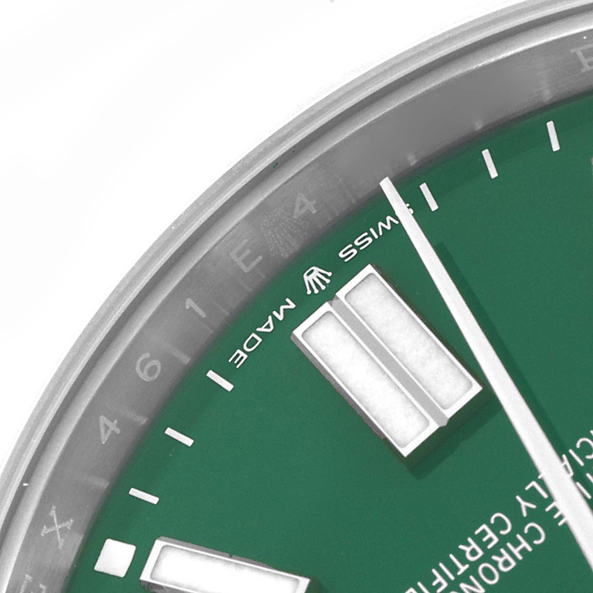 The image shows a close-up of the green dial and markers of a Rolex Oyster Perpetual 124300 Men
s Stainless Steel Green Dial 124300 Men
s Stainless Steel Green Dial watch, viewed from an angled perspective.