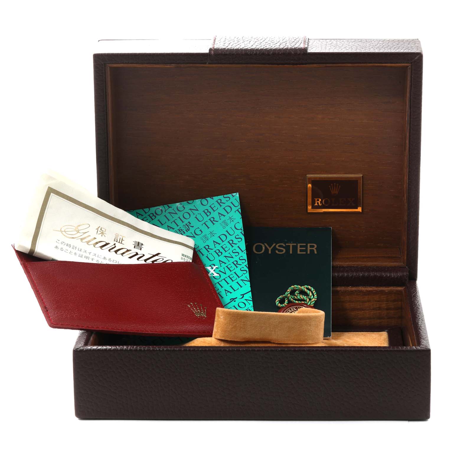 The image shows a Rolex President 118338 Men
s Yellow Gold Champagne Dial 118338 Men
s Yellow Gold Champagne Dial model watch box and its accessories, including manuals, guarantee card, and a cushion from an angled view.