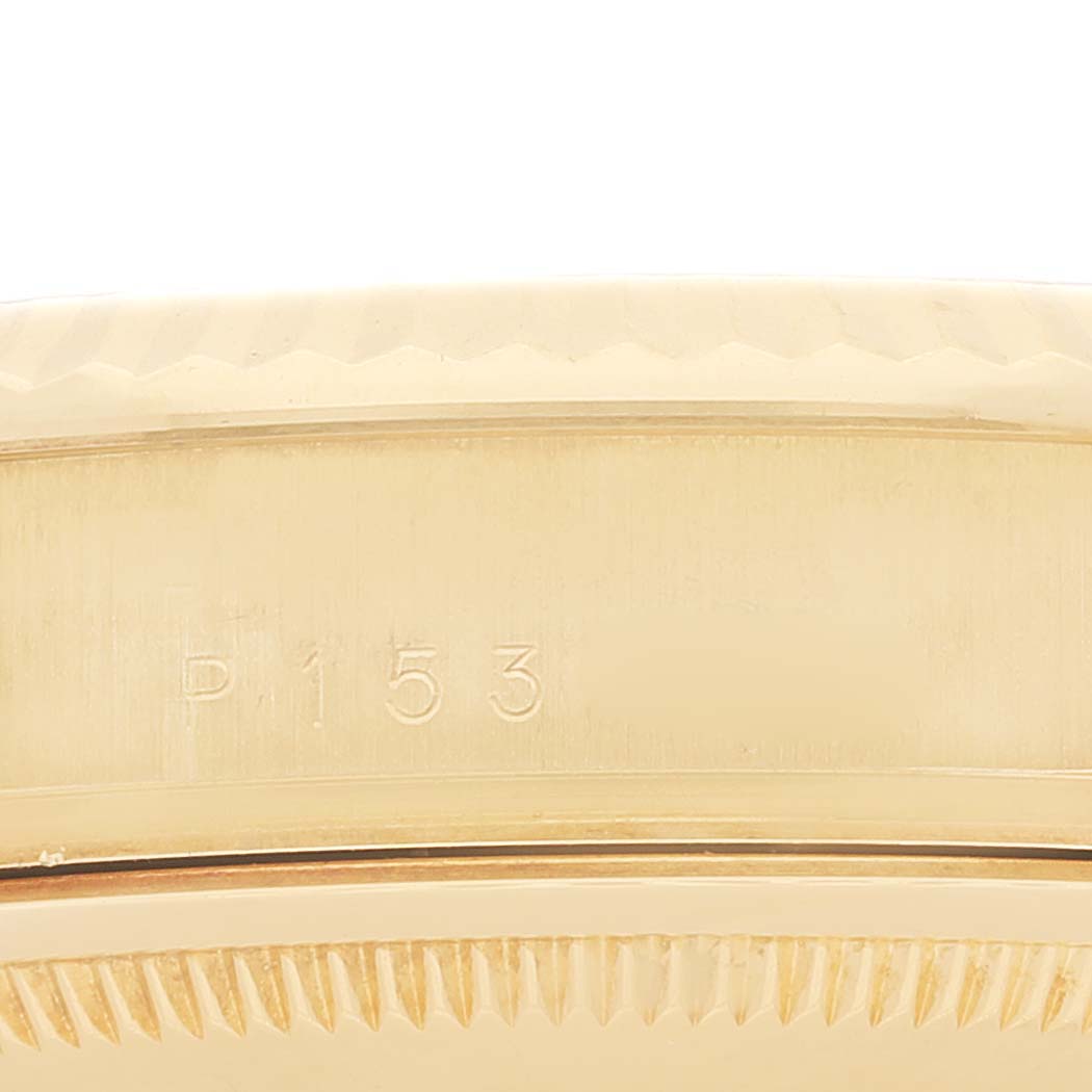 The image shows a close-up of the side of the bezel on a Rolex President 118238 Men
s Yellow Gold Champagne Dial 118238 Men
s Yellow Gold Champagne Dial model watch, featuring serial number engraving.