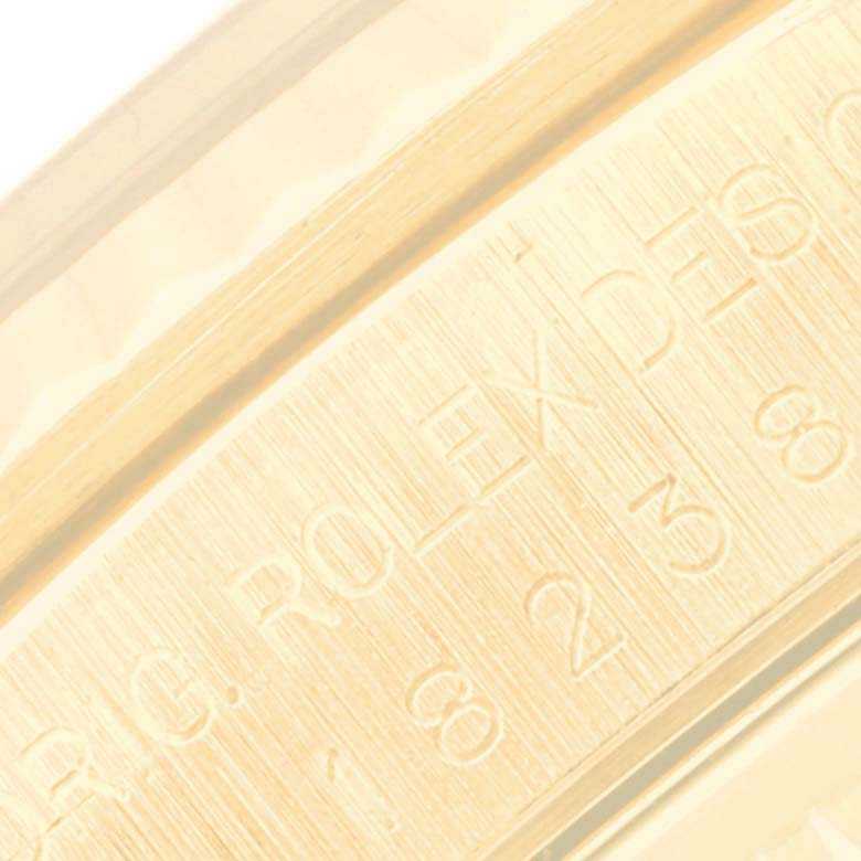 This close-up image shows the engraved details on the inner part of the band of a Rolex President 18238 Men's Yellow Gold White Dial 18238 Men's Yellow Gold White Dial model watch.