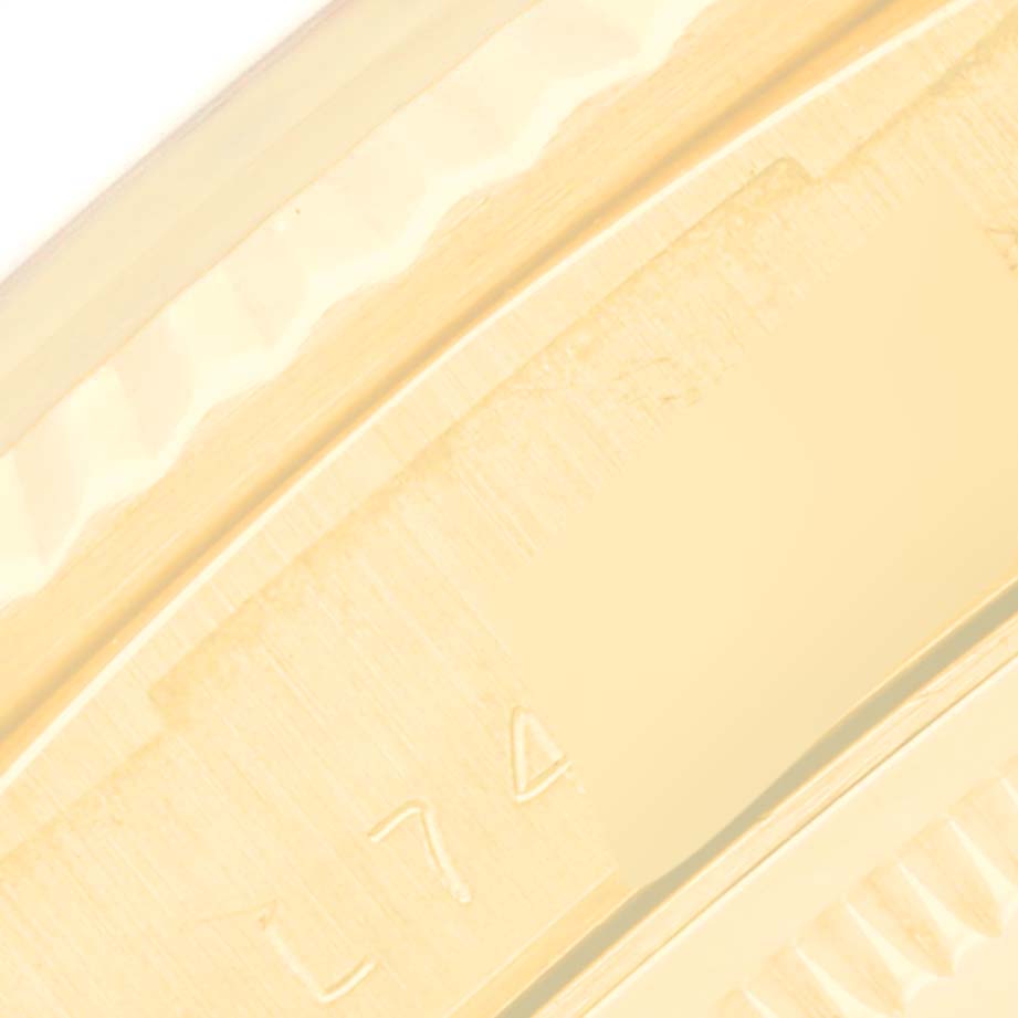 The image shows a close-up of the bezel and part of the casing of a Rolex President 18238 Men
s Yellow Gold White Dial 18238 Men
s Yellow Gold White Dial model watch.