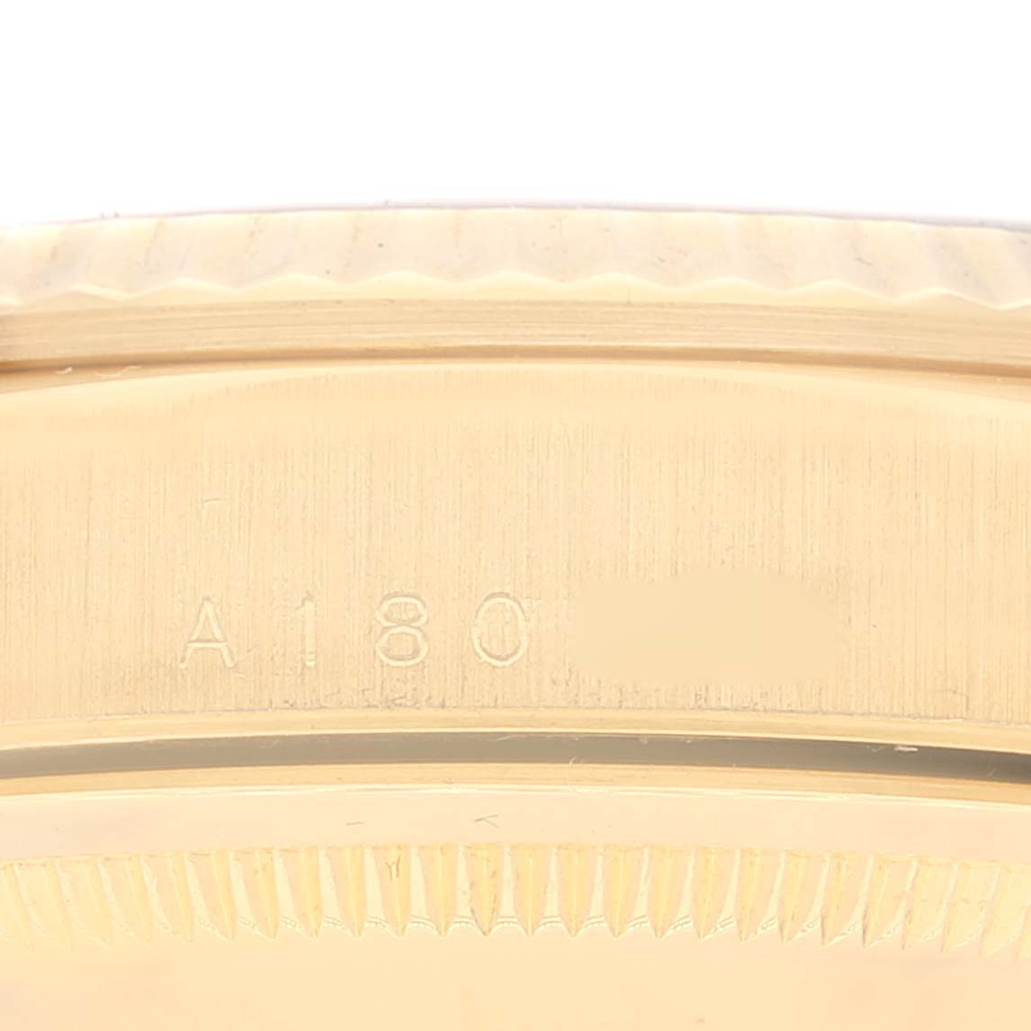 The close-up image shows the side view of the Rolex President 18238 Men's Yellow Gold Blue Dial 18238 Men's Yellow Gold Blue Dial model's gold watch case with part of its engraved model number.