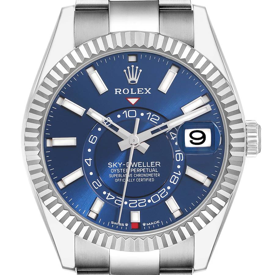 The Rolex Sky-Dweller watch is shown from the front, highlighting the blue dial, fluted bezel, and date window.