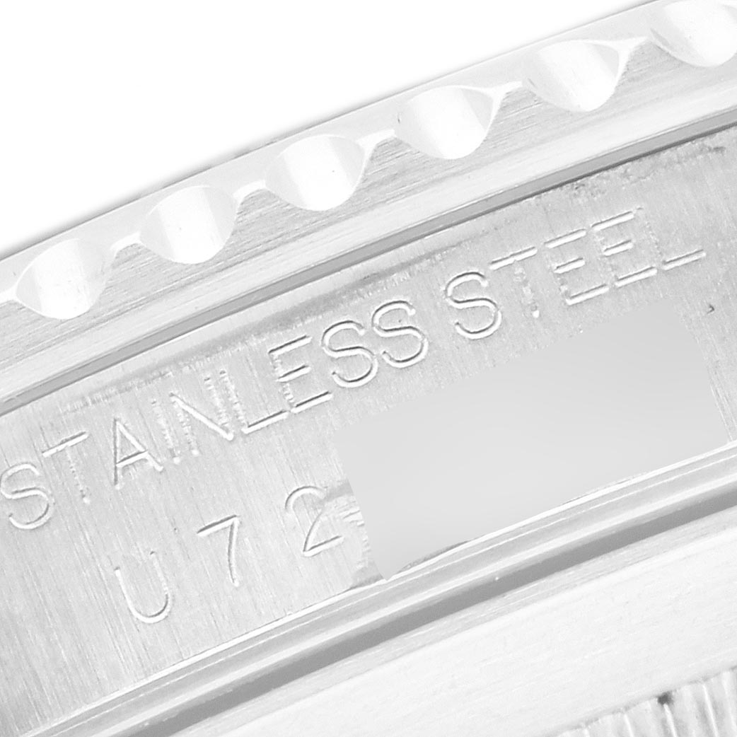 The image shows a close-up of the Rolex Submariner 14060 Men
s Stainless Steel Black Dial 14060 Men
s Stainless Steel Black Dial
s case with "STAINLESS STEEL" engraving.