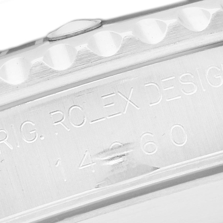 The image shows a side view of the Rolex Submariner 14060 Men
s Stainless Steel Black Dial 14060 Men
s Stainless Steel Black Dial
s case, focusing on the engraved model number.