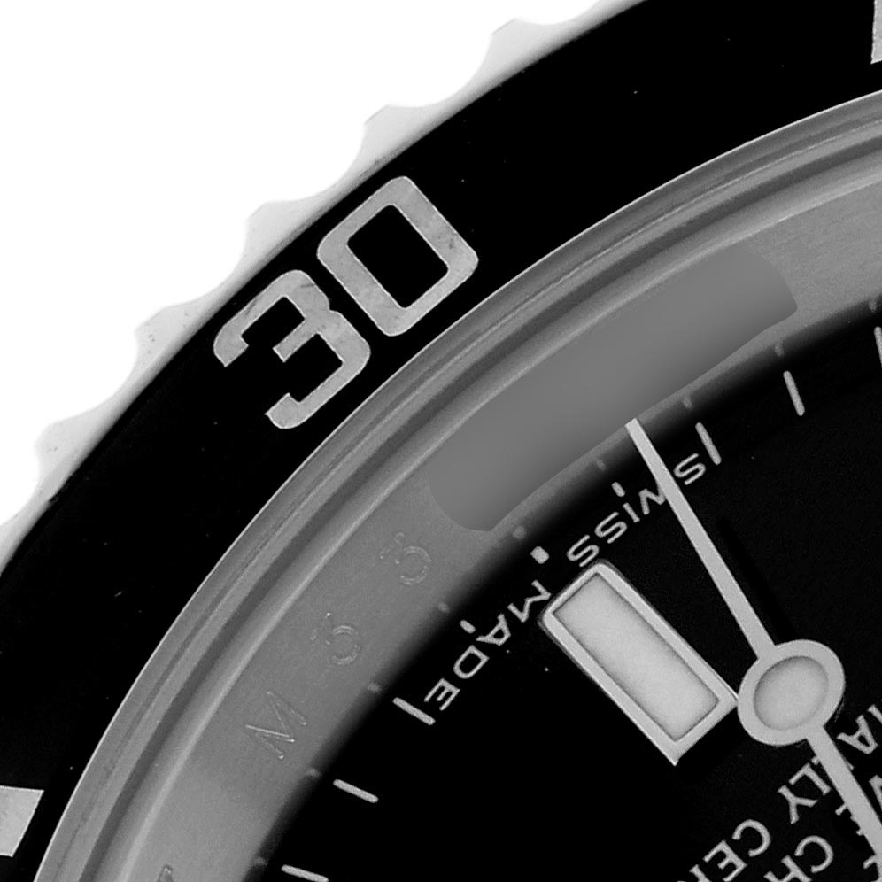 The image shows a close-up of the bezel and part of the dial of a Rolex Submariner 14060M Men
s Stainless Steel Black Dial 14060M Men
s Stainless Steel Black Dial watch.
