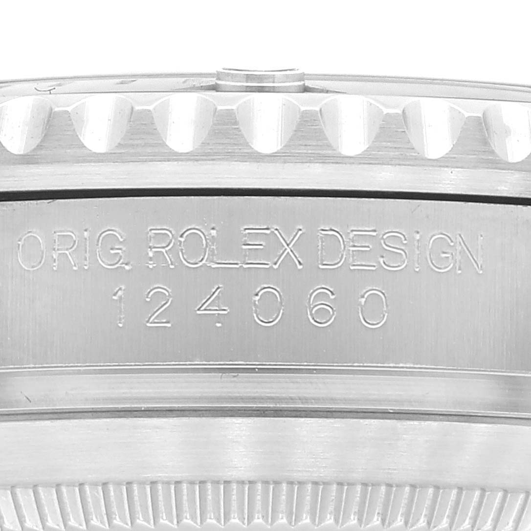 Close-up of the side of the Rolex Submariner 124060 Men
s Stainless Steel Black Dial 124060 Men
s Stainless Steel Black Dial, showing the engraving "ORIG. ROLEX DESIGN 124060."