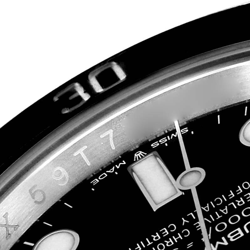 The image shows a close-up of the bezel and part of the dial of a Rolex Submariner 124060 Men
s Stainless Steel Black Dial 124060 Men
s Stainless Steel Black Dial watch, focusing on the 30-minute mark.