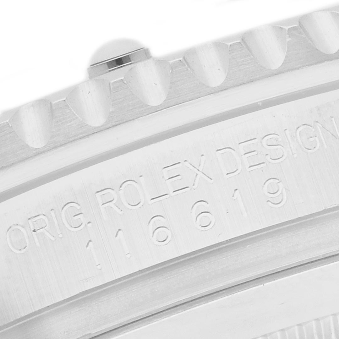 The image shows a close-up of the bezel and engraved edge of the Rolex Submariner 116619 Men
s White Gold Blue Dial 116619 Men
s White Gold Blue Dial, highlighting the model number and "ROLEX DESIGN."