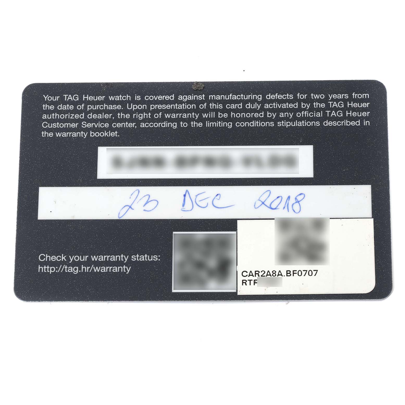 This is a warranty card for the Tag Heuer Carrera CAR2A8A.BF0707 Men's Titanium Grey Dial CAR2A8A.BF0707 Men's Titanium Grey Dial model watch, shown from a top-down angle.