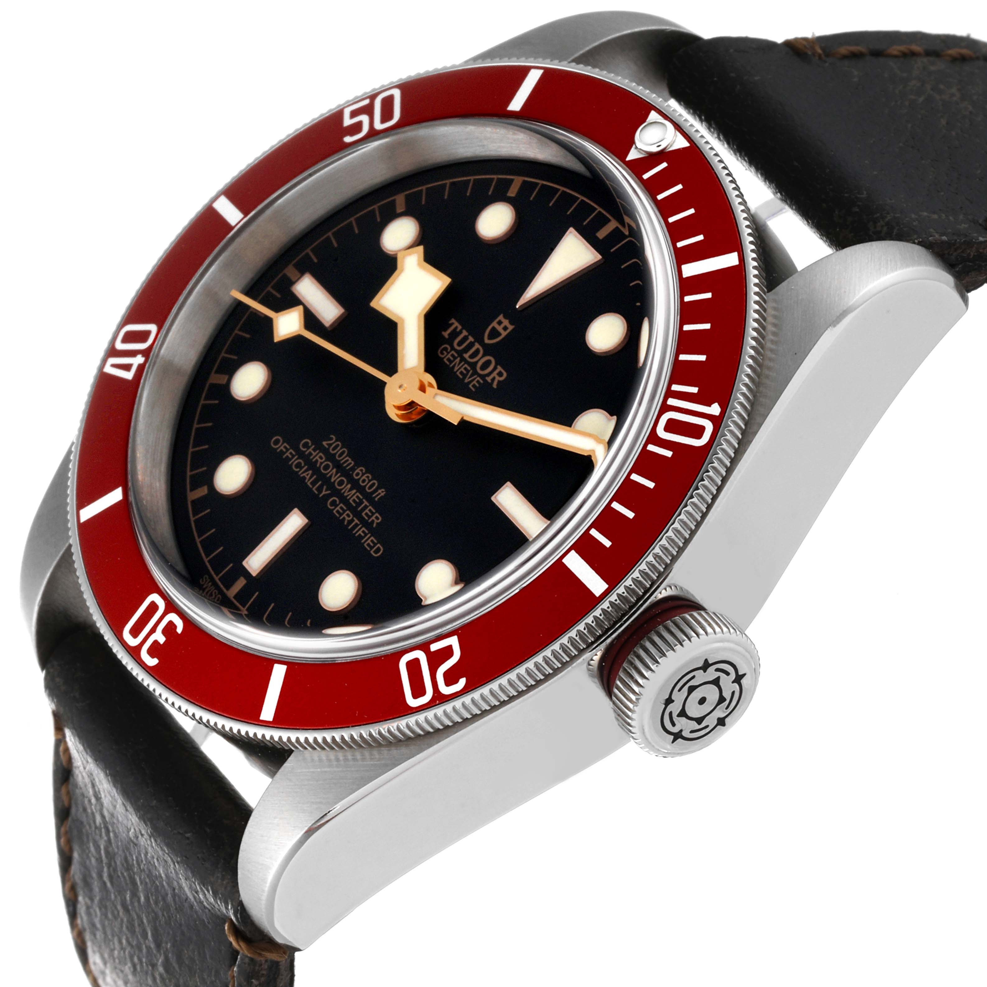 This side-angle shot of the Tudor Heritage Black Bay M79230R-0010 Men's Stainless Steel Black Dial M79230R-0010 Men's Stainless Steel Black Dial watch showcases the dial, red bezel, crown, and leather strap.