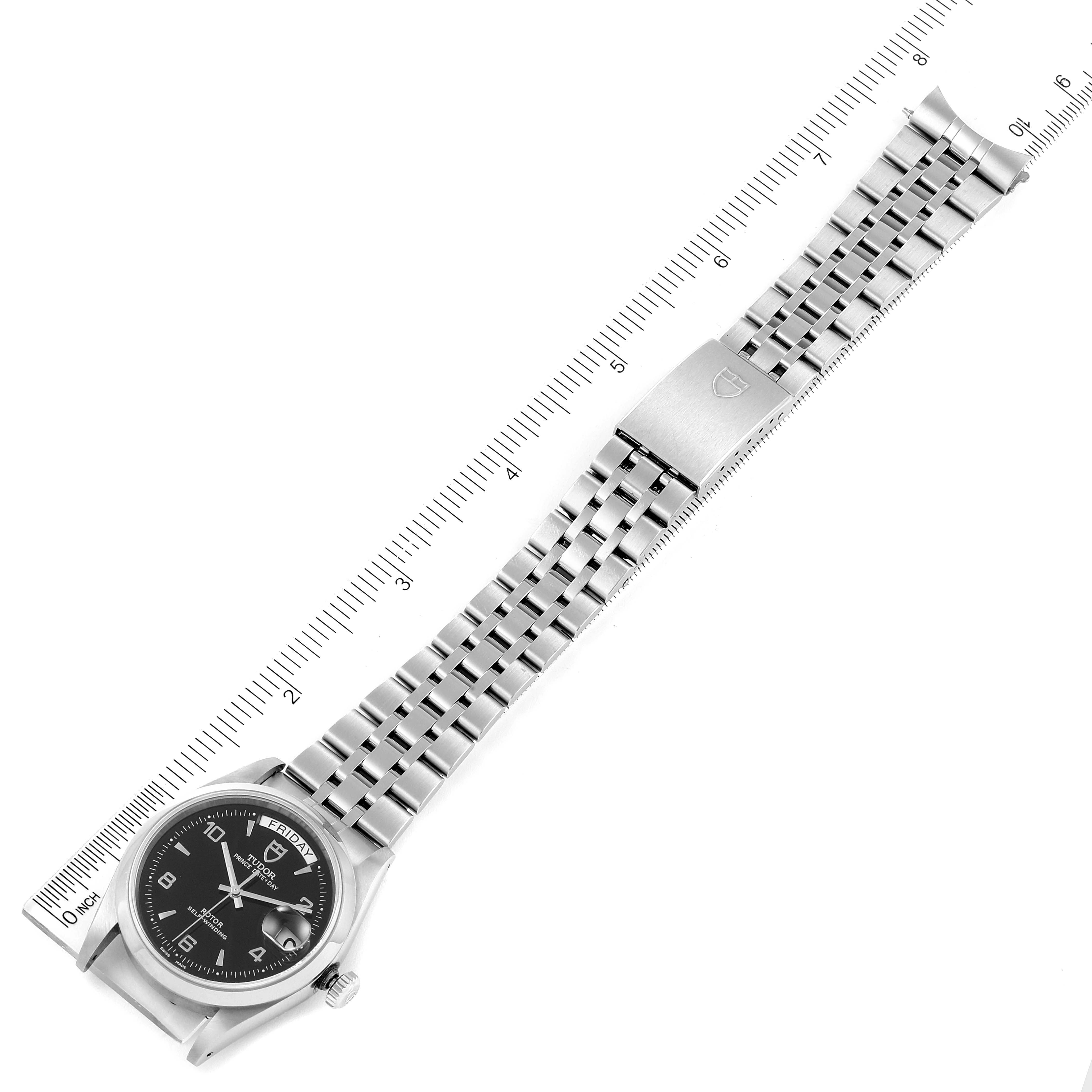 The image shows a full view of the Tudor Prince 76200 Men's Stainless Steel Black Dial 76200 Men's Stainless Steel Black Dial watch, including the face, bracelet, and clasp, against a ruler for scale.