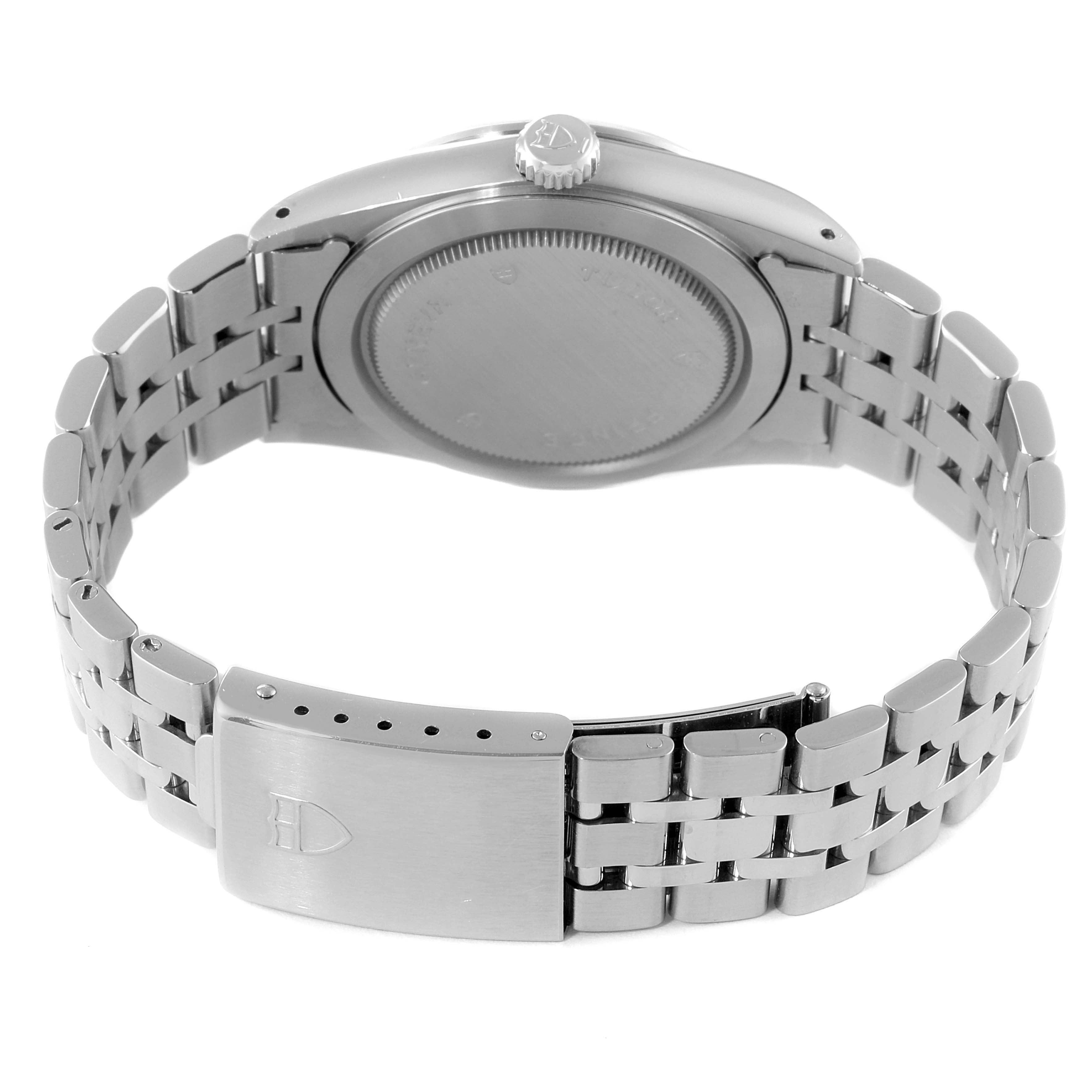 The image shows the back of a Tudor Prince 76200 Men's Stainless Steel Black Dial 76200 Men's Stainless Steel Black Dial model watch, highlighting its case back, crown, and metal bracelet with clasp.