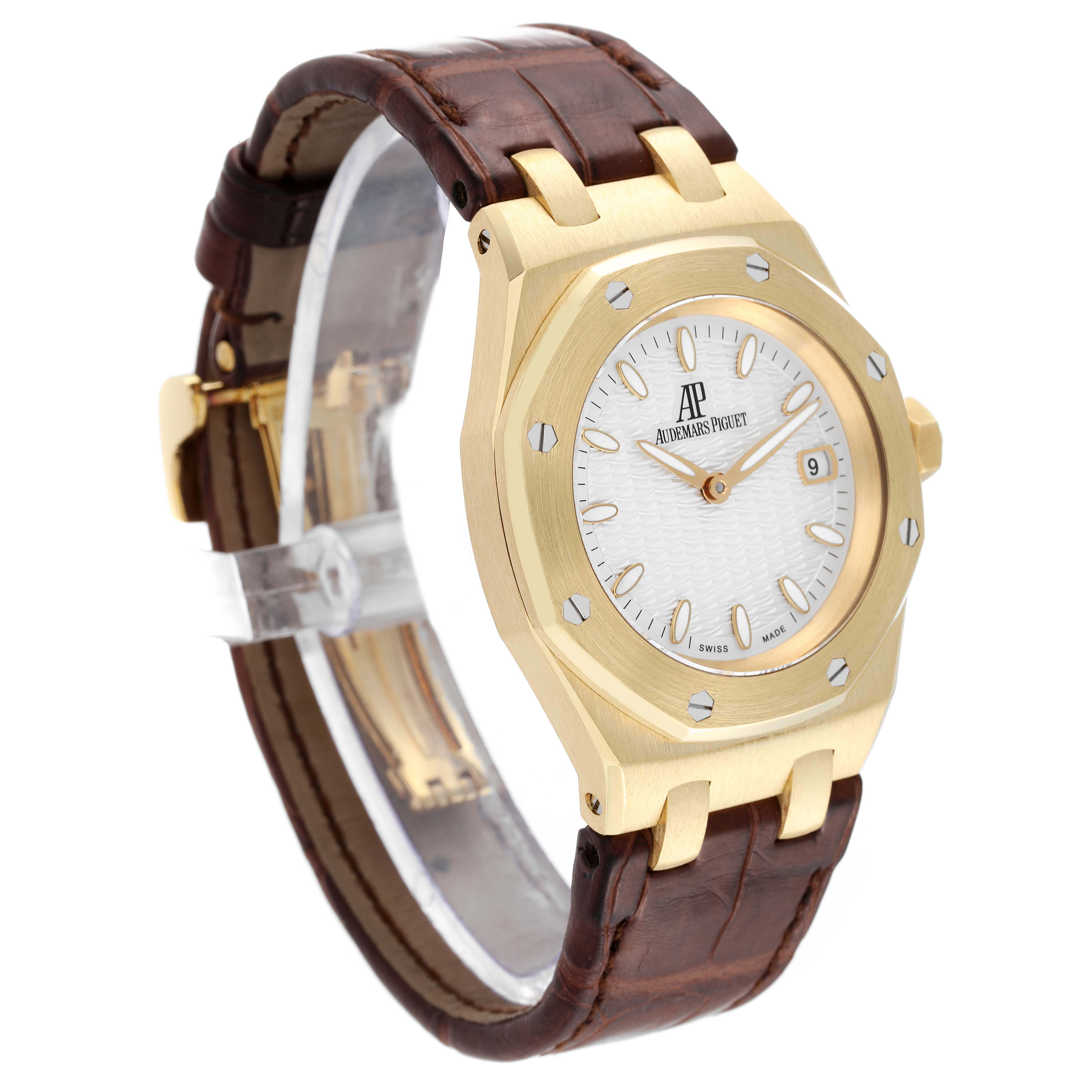 The image shows a side-angle view of an Audemars Piguet Royal Oak 67600BA Women's Yellow Gold Silver Dial 67600BA Women's Yellow Gold Silver Dial watch, highlighting the face, bezel, and leather strap.
