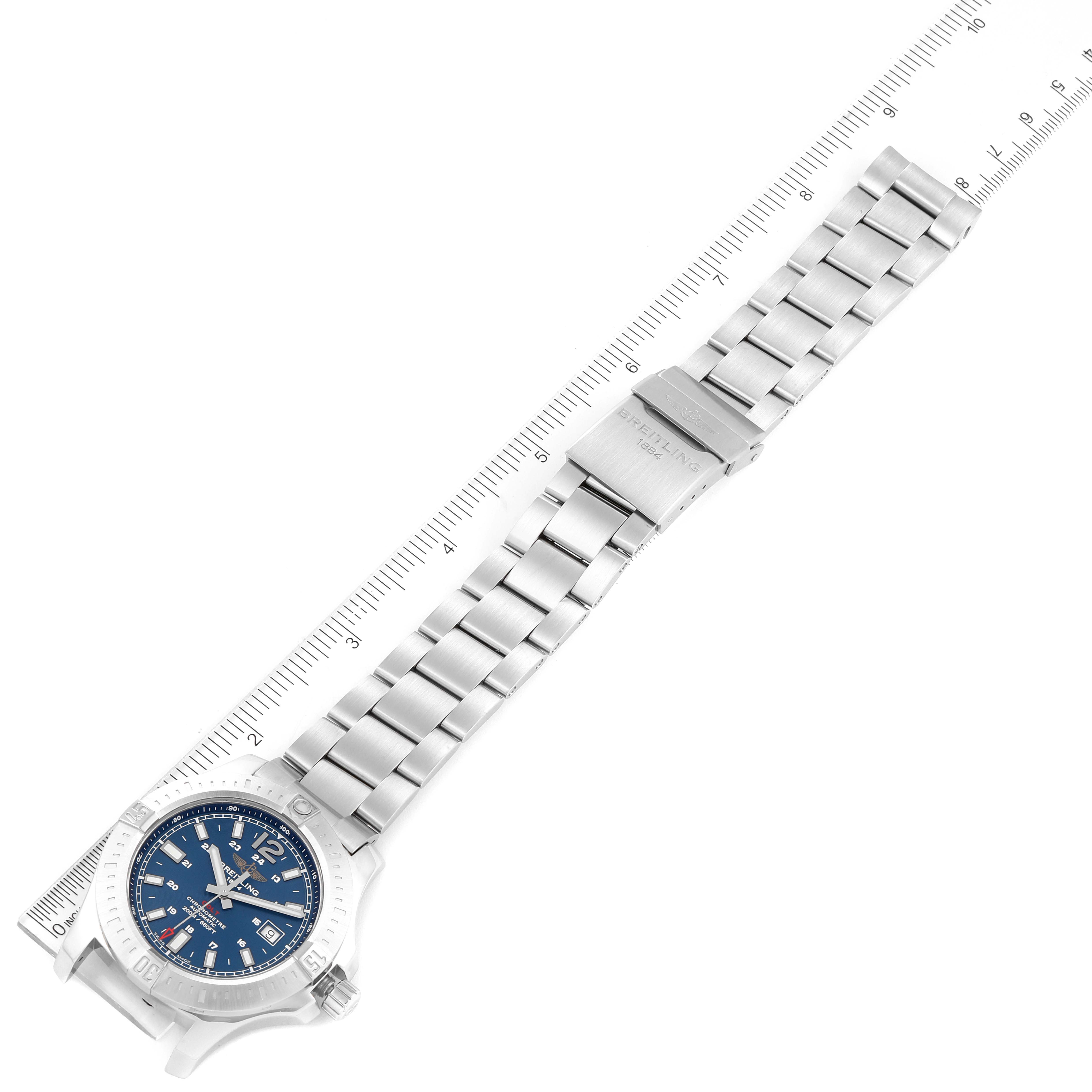 The image shows a top-down view of a Breitling Colt A17388 Men's Stainless Steel Blue Dial A17388 Men's Stainless Steel Blue Dial watch and its stainless steel bracelet against a ruler for size reference.