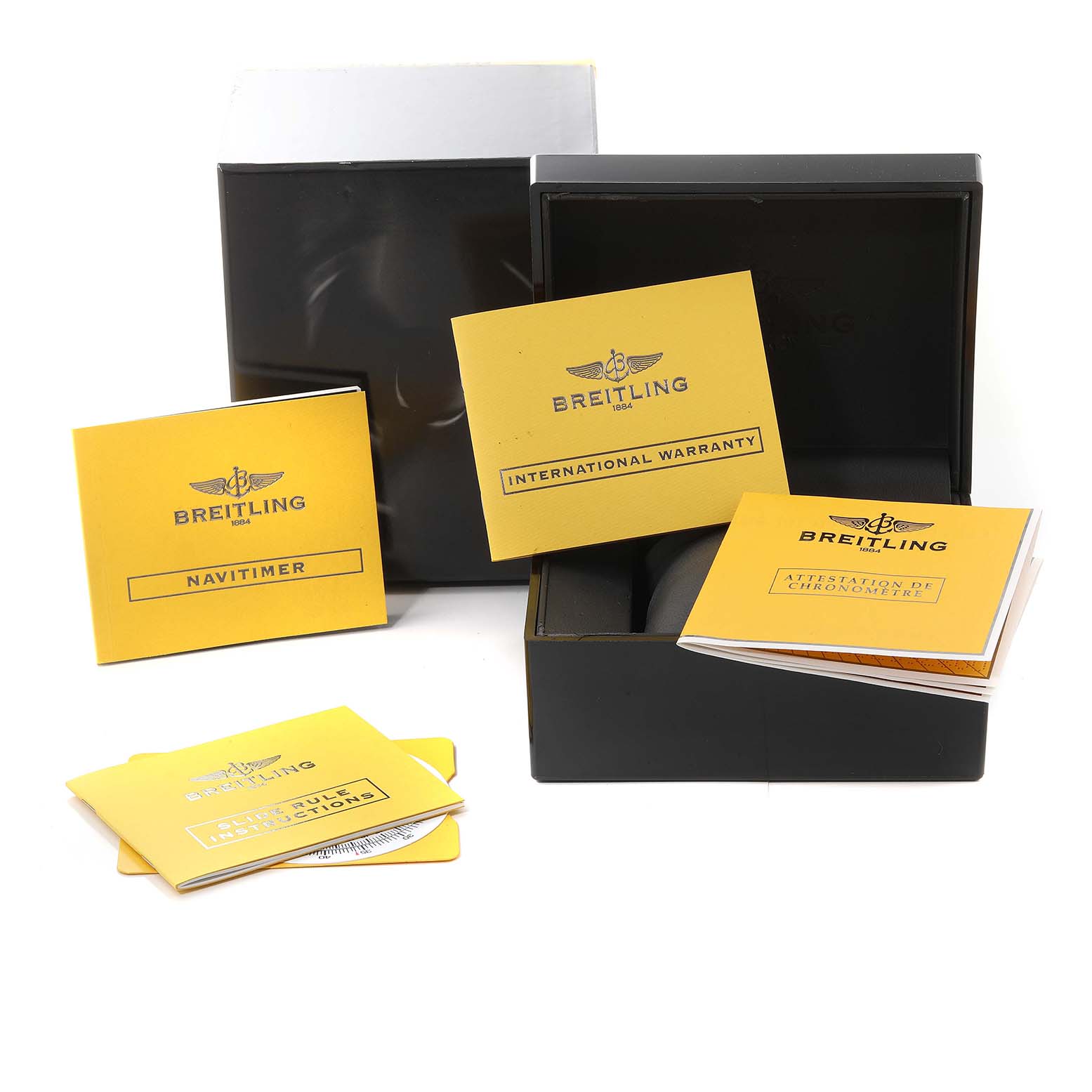 This image shows accessories for a Breitling Navitimer A23322 Men
s Stainless Steel Black Dial A23322 Men
s Stainless Steel Black Dial watch, including booklets and packaging, from a front angle.