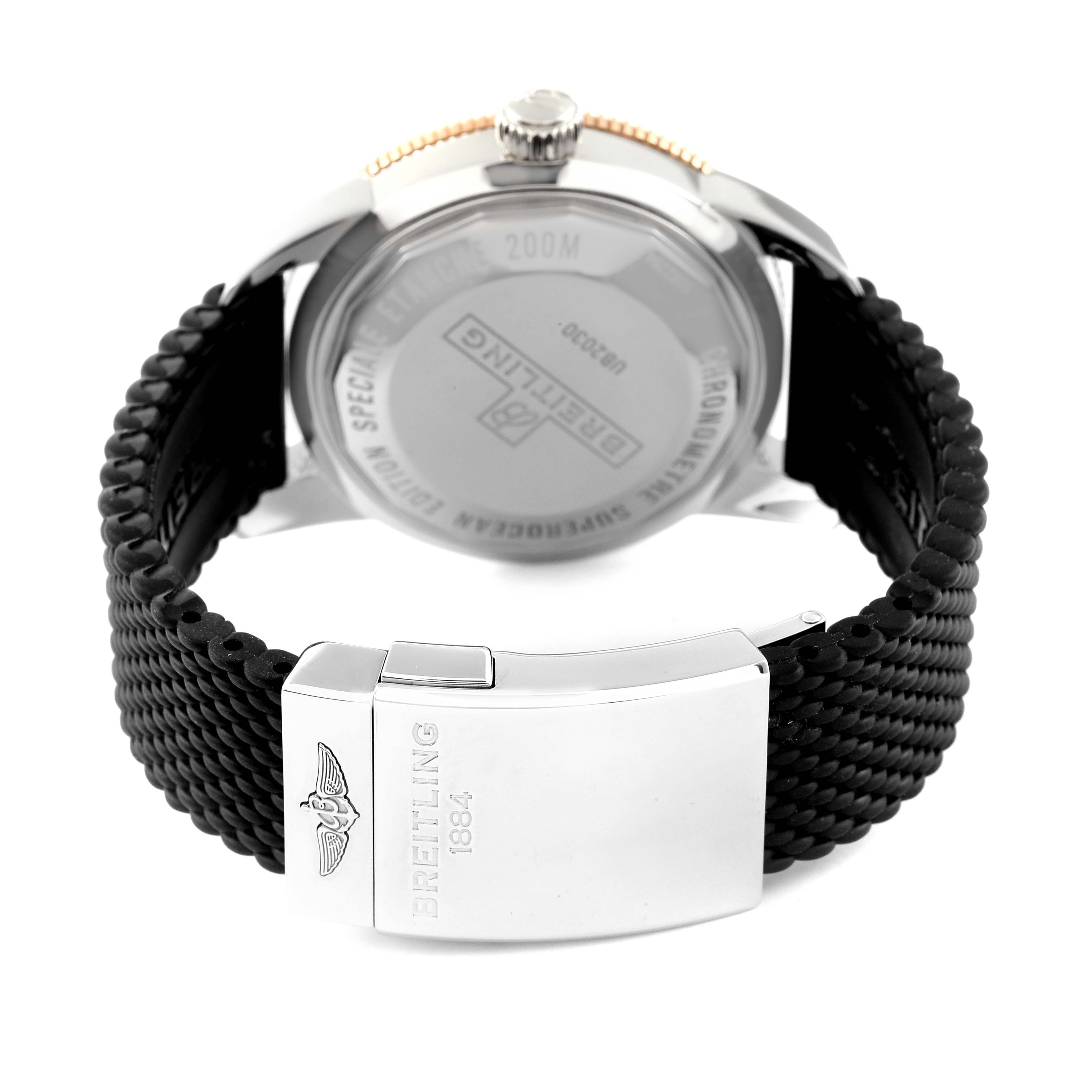 This image shows the back of a Breitling Superocean UB2030121B1A1 Men's Steel and Gold (two tone) Black Dial UB2030121B1A1 Men's Steel and Gold (two tone) Black Dial watch with its silver clasp and black textured strap.