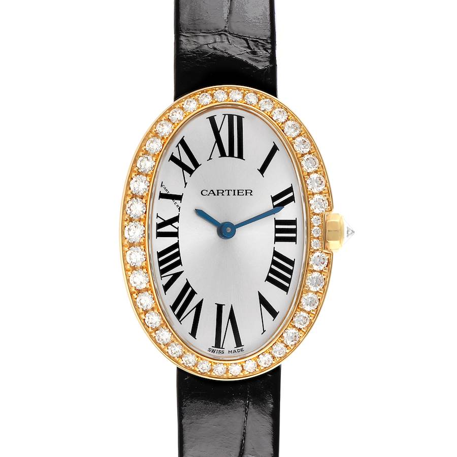 The Cartier Baignoire watch is shown from the front, featuring a diamond-set oval bezel, Roman numerals, and blue hands.