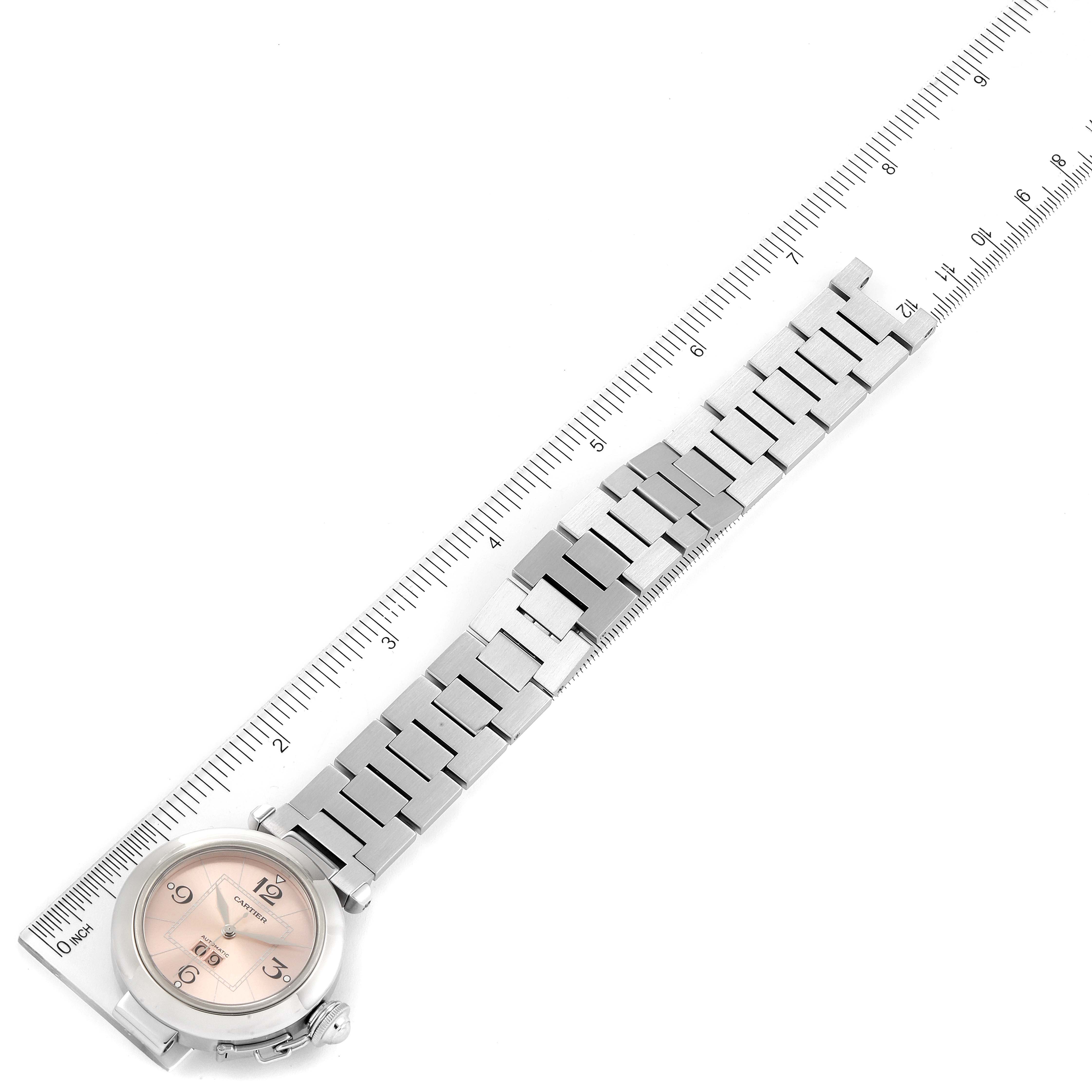 This image shows the Cartier Pasha W31058M7 Women's Stainless Steel Pink Dial W31058M7 Women's Stainless Steel Pink Dial model watch laid flat with its bracelet measured against a ruler.