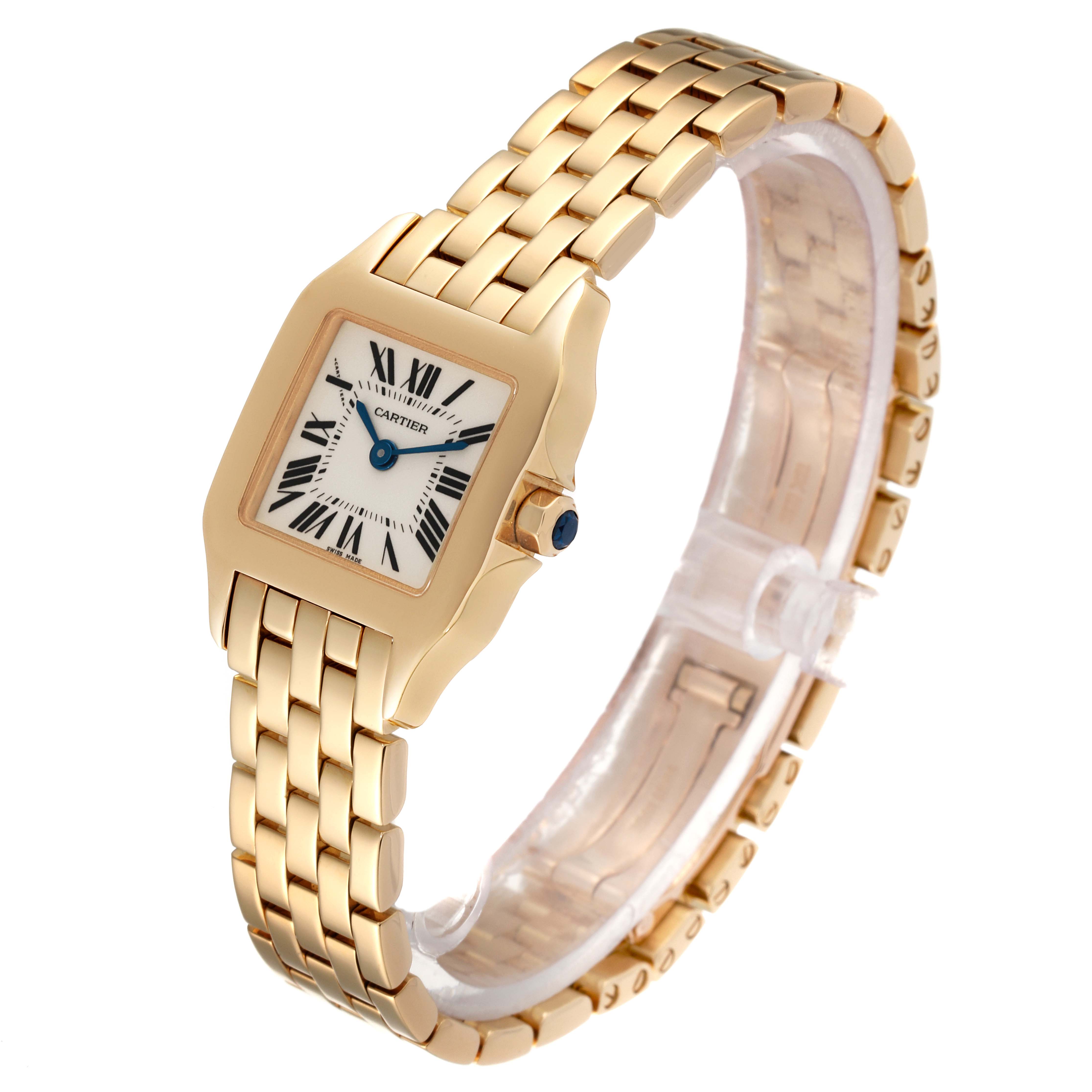 The image shows a Cartier Santos Demoiselle W25063X9 Women
s Yellow Gold Silver Dial W25063X9 Women
s Yellow Gold Silver Dial watch from a three-quarter angle, highlighting its gold link bracelet and square face.