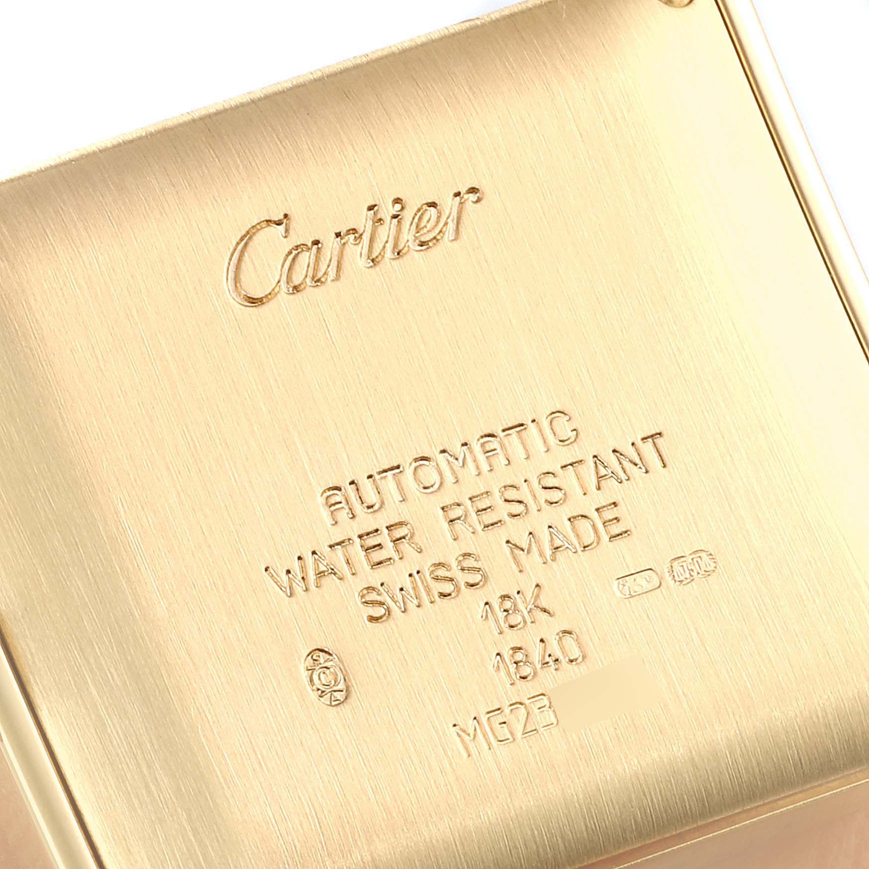 The image shows the back case of a Cartier Tank Française watch, highlighting its engravings and markings.