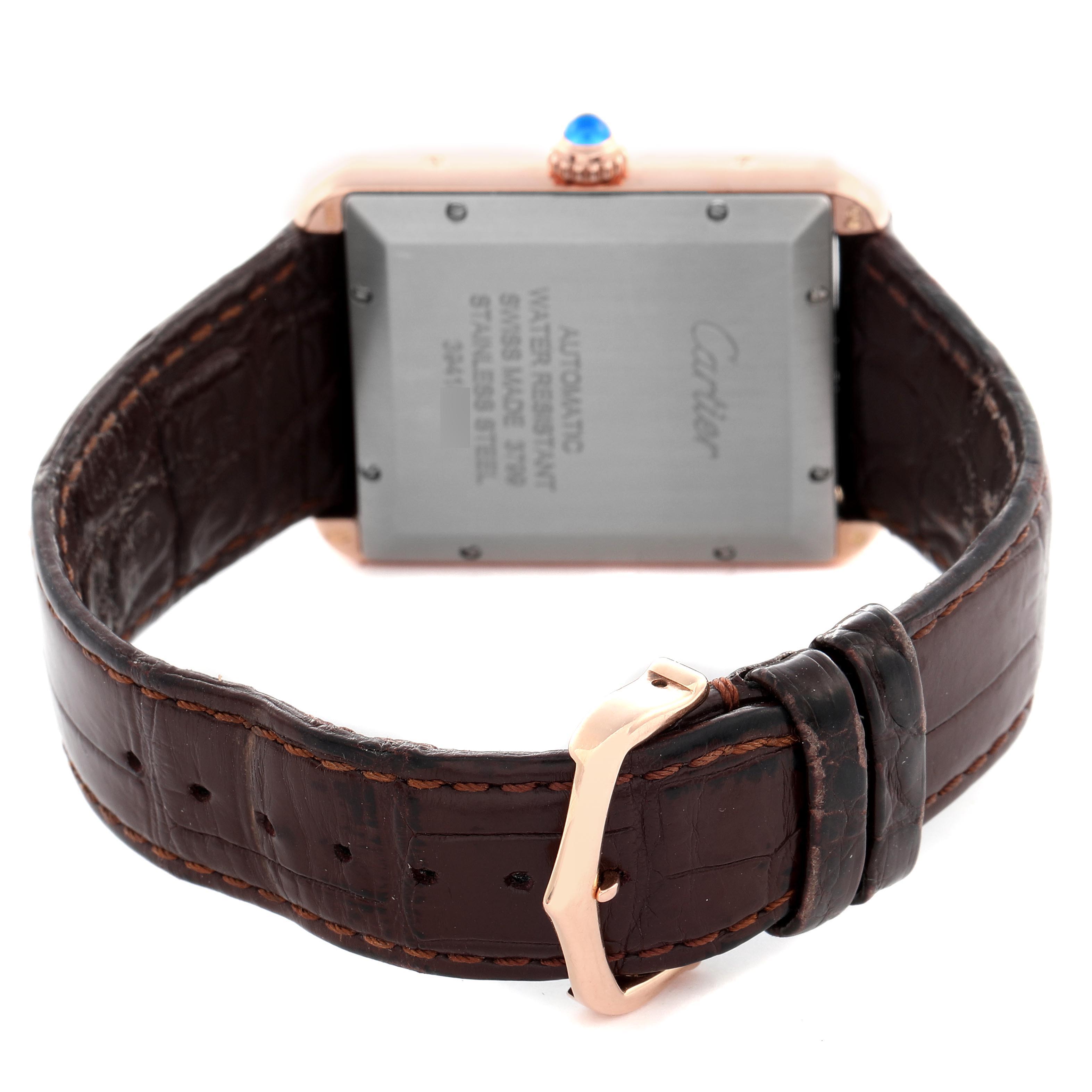 The image shows the back view of a Cartier Tank Solo W5200026 Men
s Steel and Gold (two tone) Silver Dial W5200026 Men
s Steel and Gold (two tone) Silver Dial watch, highlighting the case back, crown, and brown leather strap with a clasp.