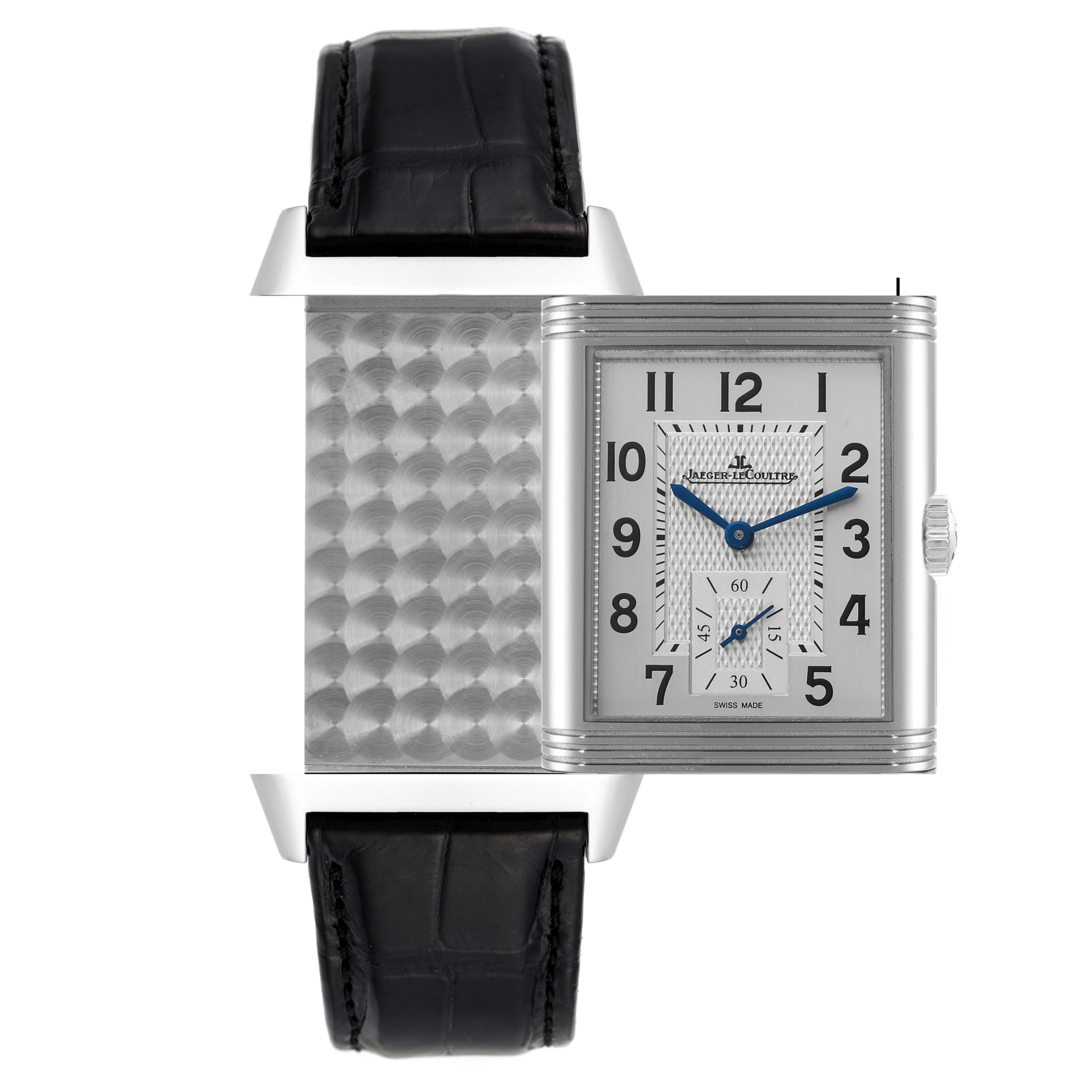 The Reverso model by Jaeger LeCoultre is shown from a frontal angle, displaying its unique swiveling case and rectangular dial.