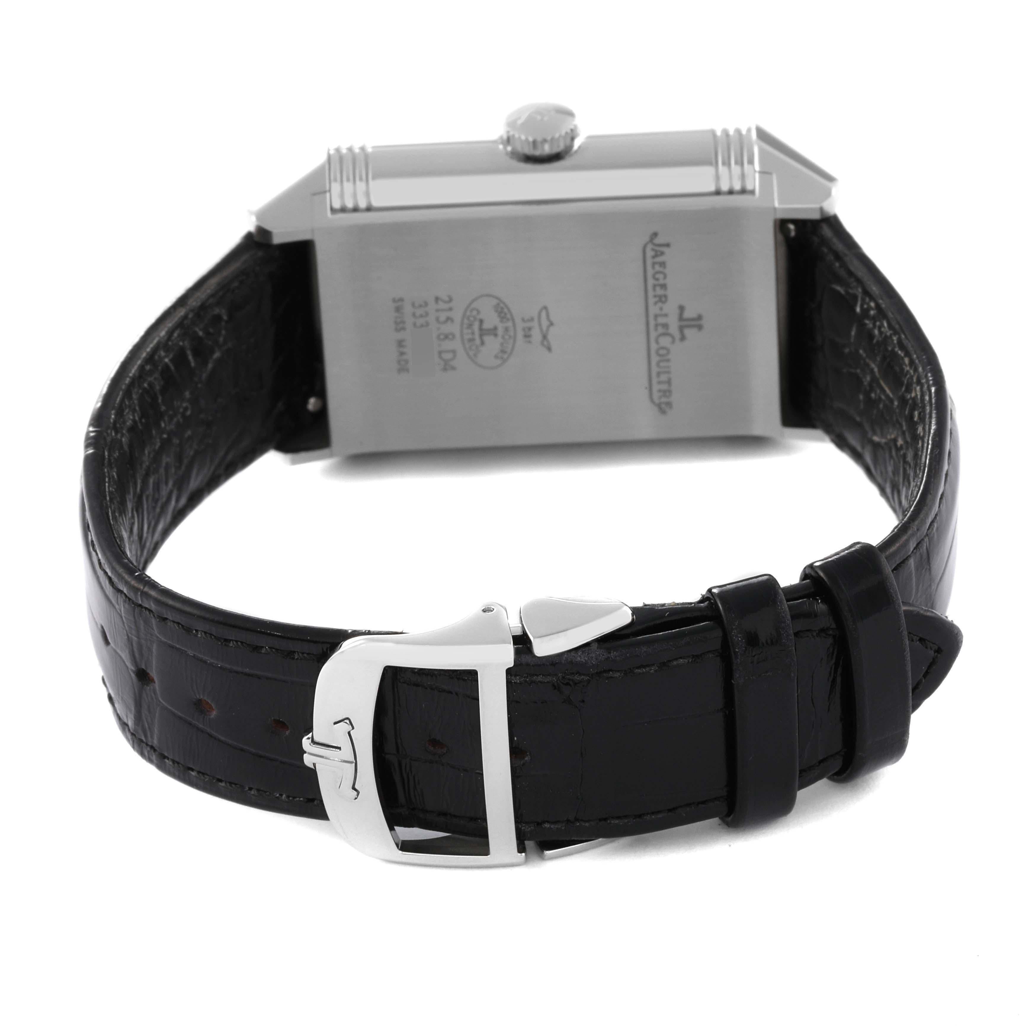 This image shows the back of a Jaeger LeCoultre Reverso Q3848420 Men's Stainless Steel Silver Dial Q3848420 Men's Stainless Steel Silver Dial watch, highlighting its caseback, crown, and leather strap with a buckle.