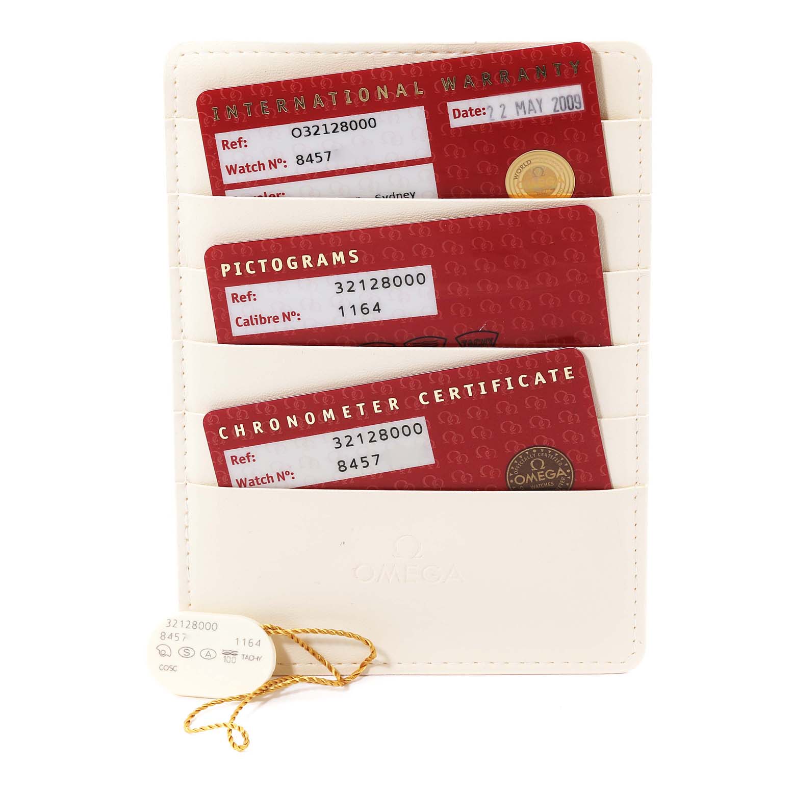 The image shows warranty cards and certificates for an Omega Speedmaster 3212.80.00 Men
s Stainless Steel Blue Dial 3212.80.00 Men
s Stainless Steel Blue Dial watch, arranged in a holder, viewed from above.