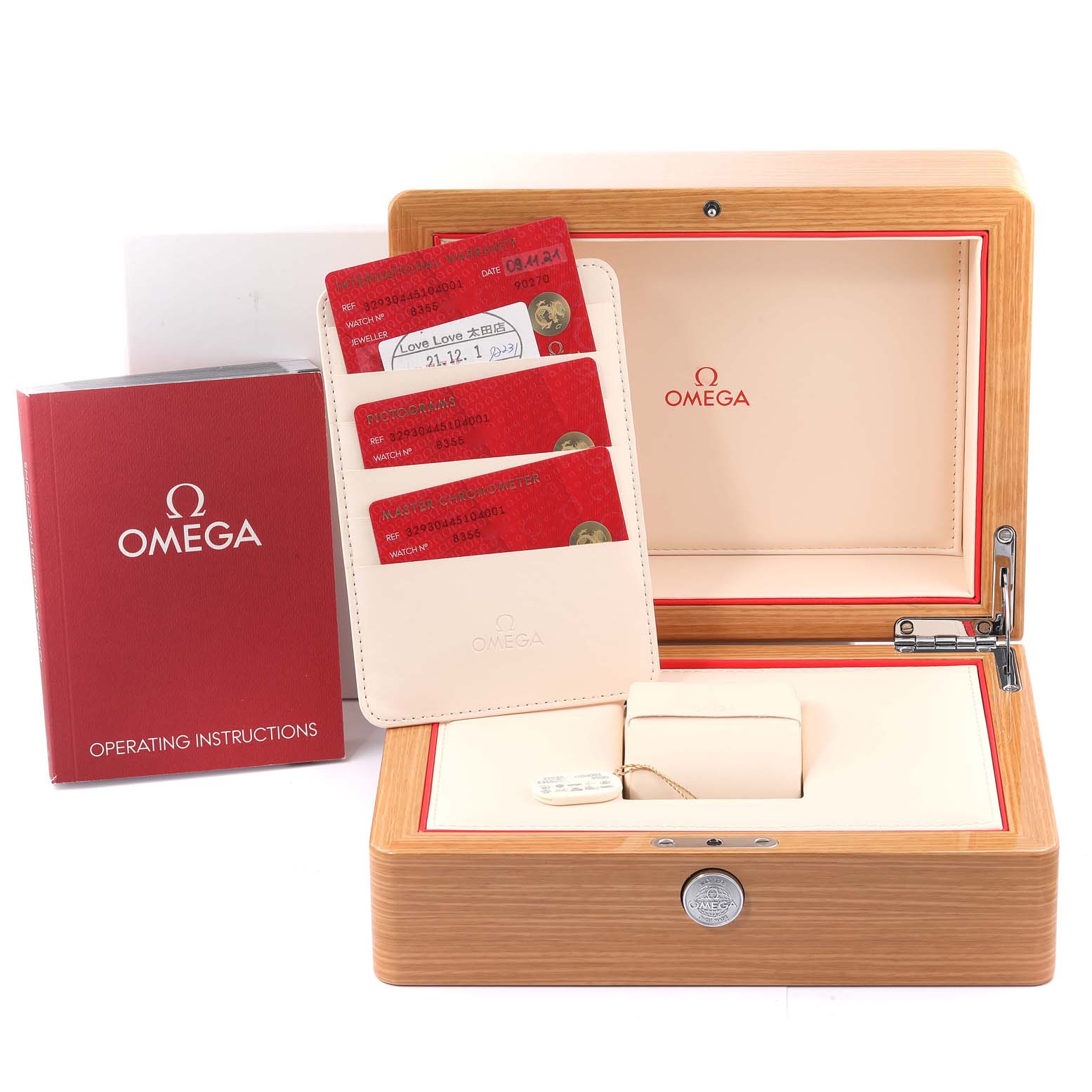The image shows an Omega Speedmaster 329.30.44.51.04.001 Men
s Stainless Steel White Dial 329.30.44.51.04.001 Men
s Stainless Steel White Dial watch box, instruction manual, warranty cards, and a cardholder from a front angle.