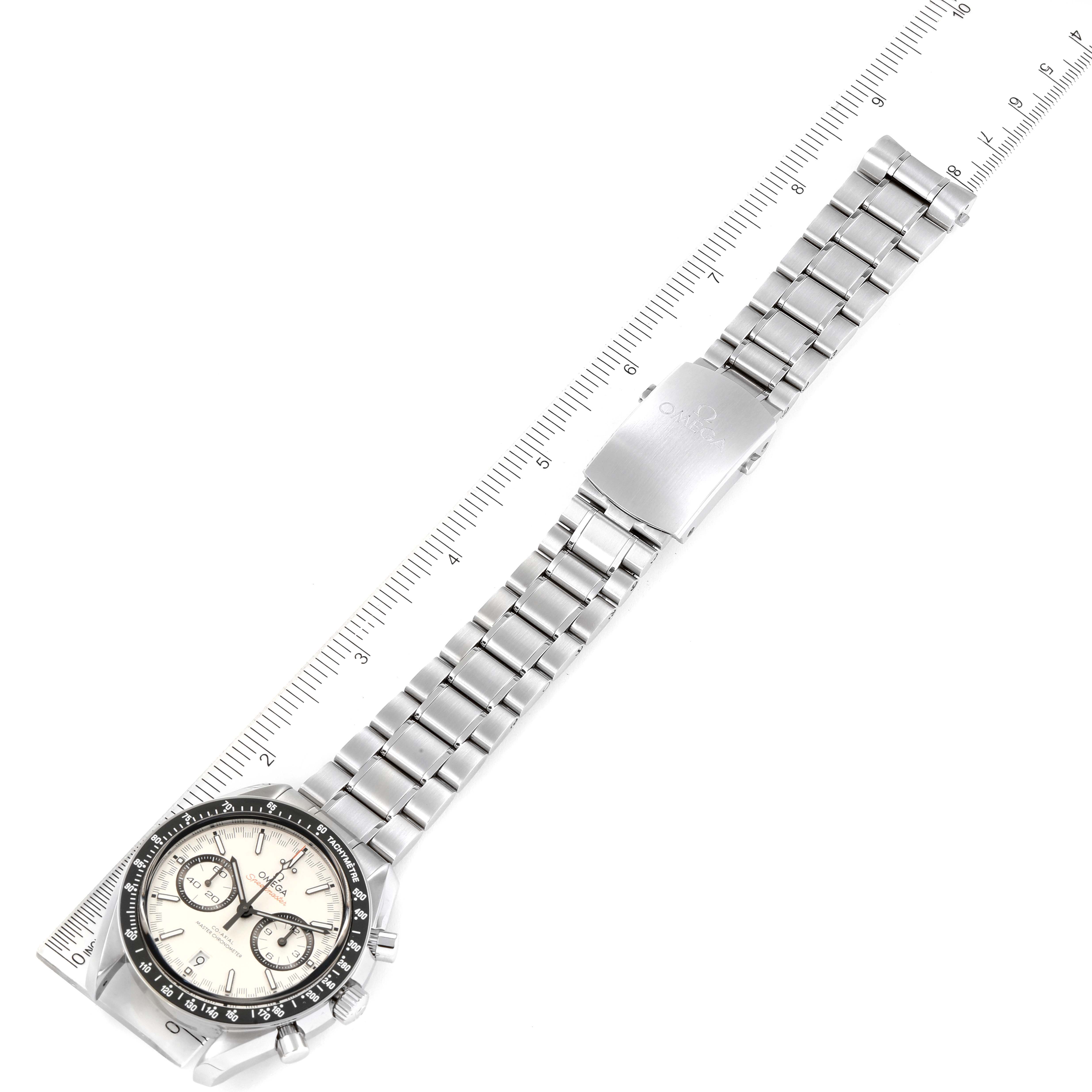 The image shows an Omega Speedmaster 329.30.44.51.04.001 Men
s Stainless Steel White Dial 329.30.44.51.04.001 Men
s Stainless Steel White Dial watch and its full bracelet laid flat, featuring a ruler for scale measurement.