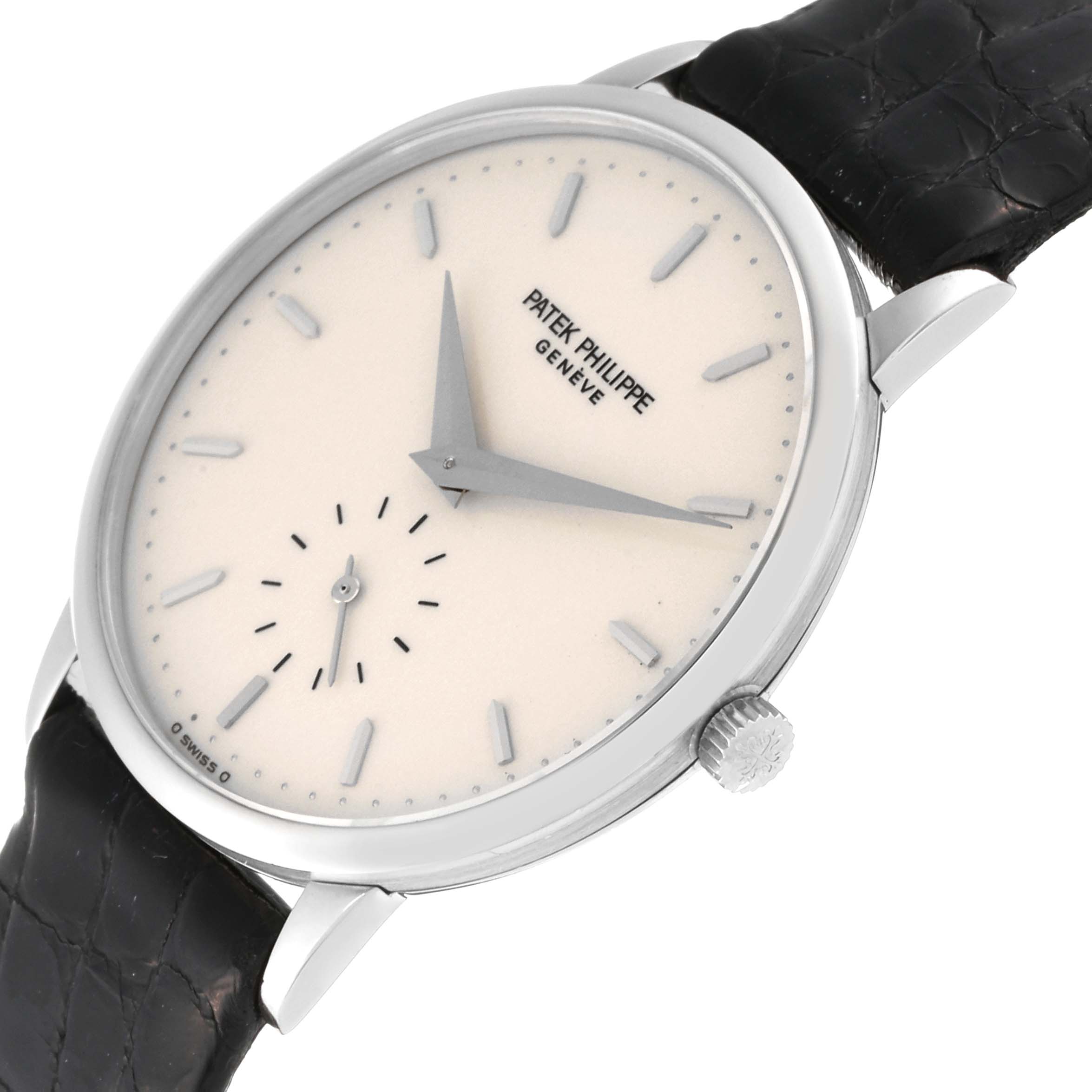 This image shows a Patek Philippe Calatrava 3893G Men
s White Gold White Dial 3893G Men
s White Gold White Dial watch from an angled top view, highlighting the dial, hands, and crown.
