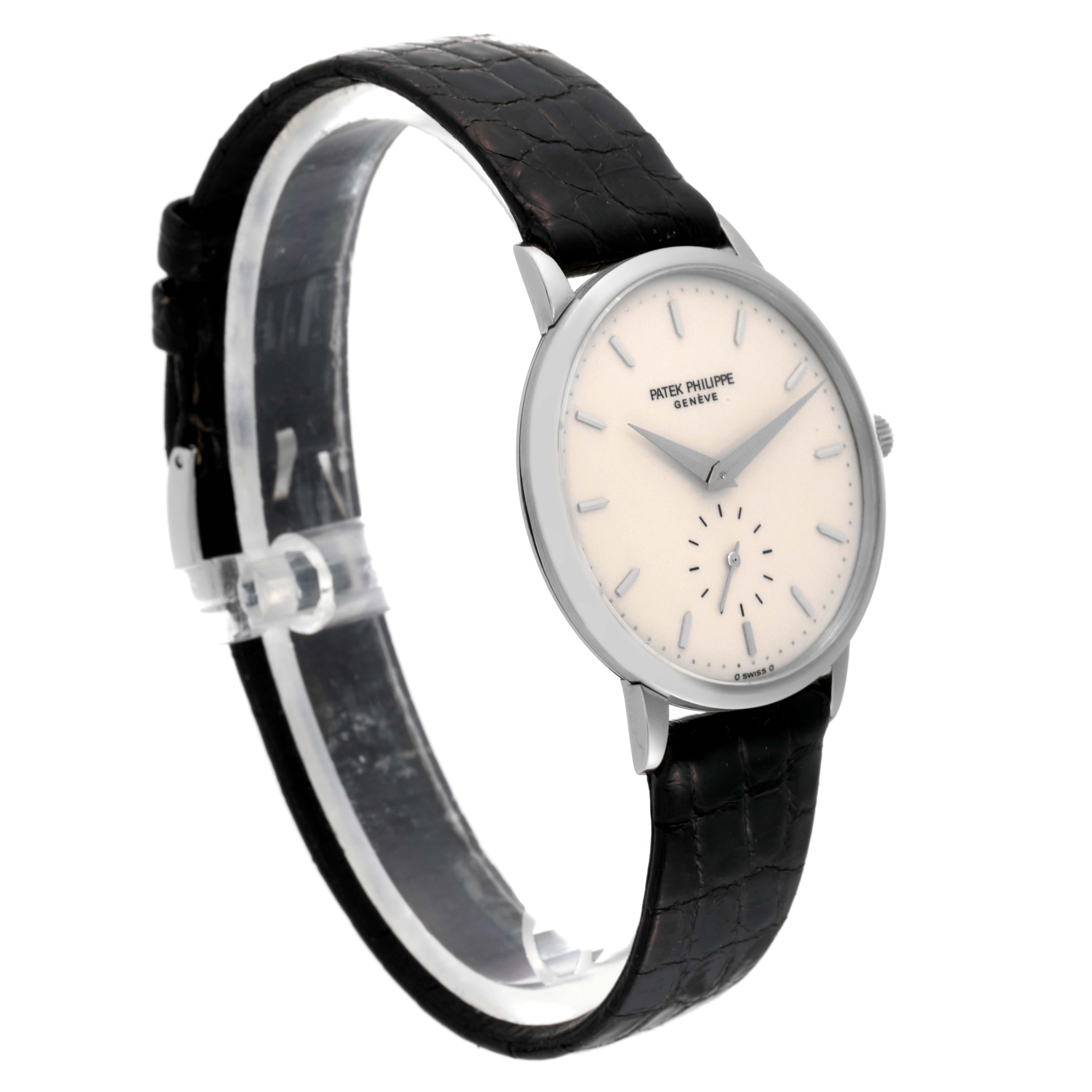 This image shows a side angle of the Patek Philippe Calatrava 3893G Men
s White Gold White Dial 3893G Men
s White Gold White Dial watch, highlighting its face, bezel, and black leather strap.