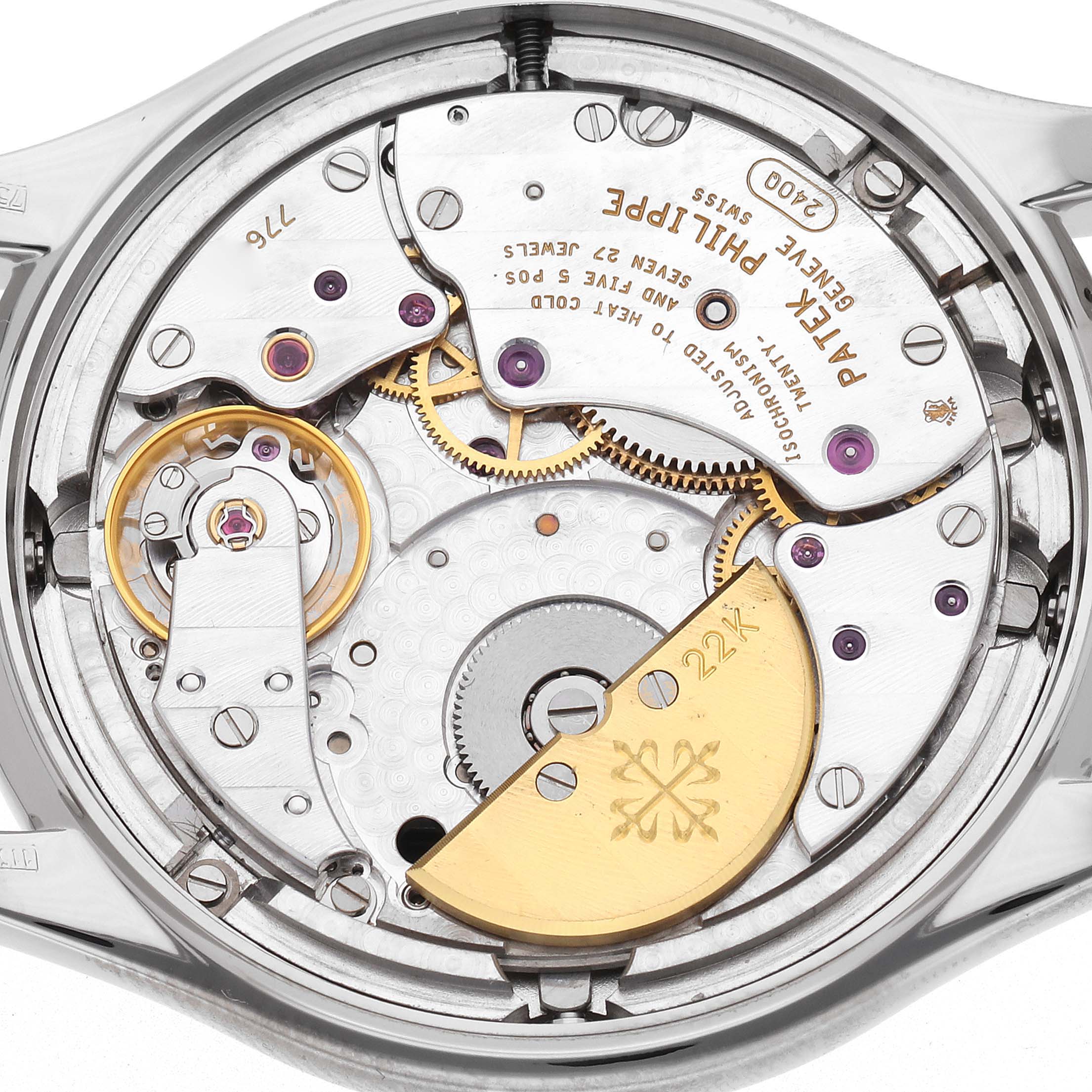 The image shows the back view of a Patek Philippe Complications 5038G Men
s White Gold Black Dial 5038G Men
s White Gold Black Dial model, highlighting its intricate mechanical movement and rotor.