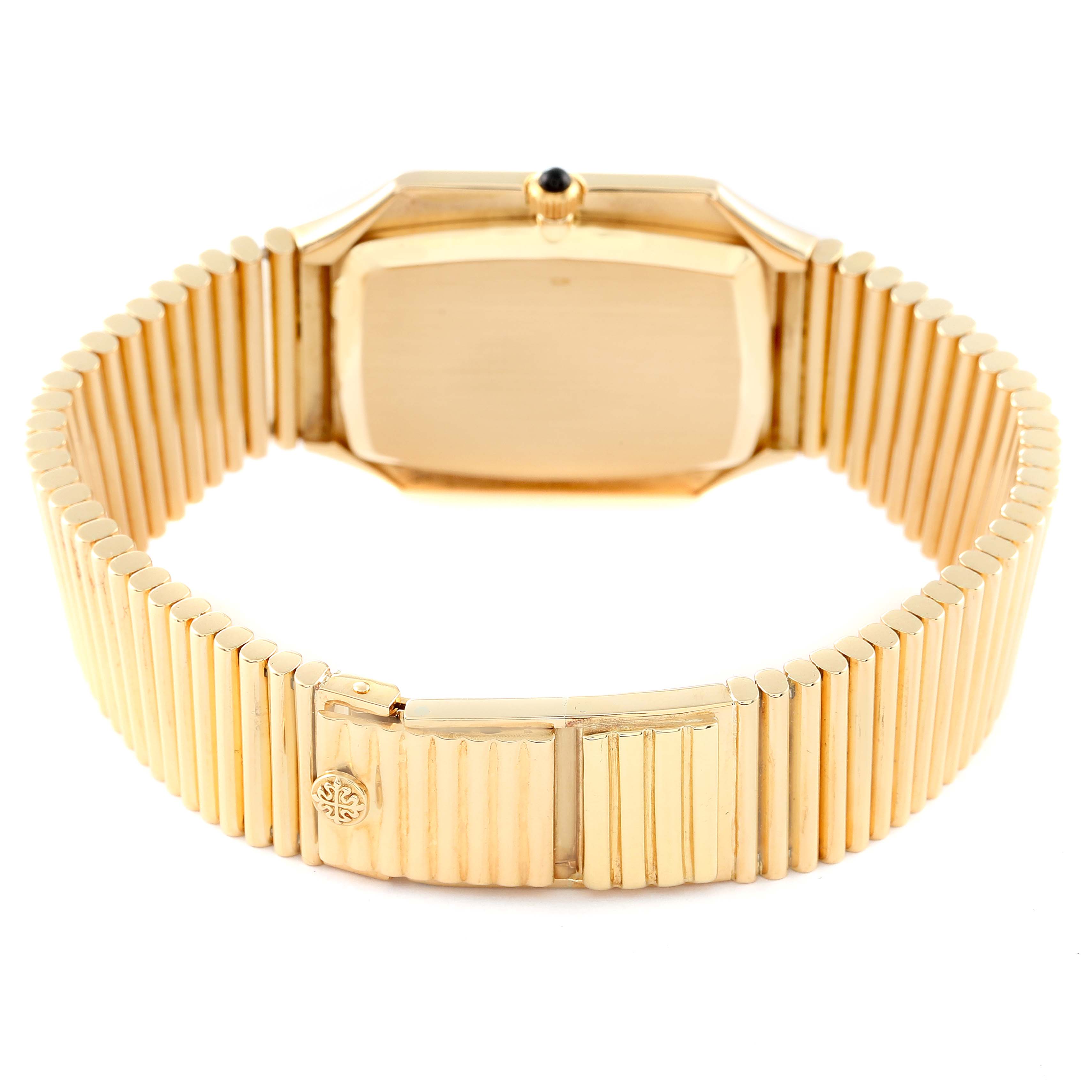 The image shows the backside and clasp of a vintage Patek Philippe watch in gold, highlighting its bracelet and case back.
